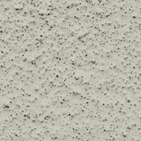 Surface de béton clair avec de petites taches sombres.