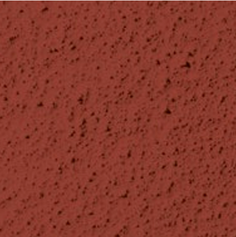 Surface en béton rouge avec des taches noires.