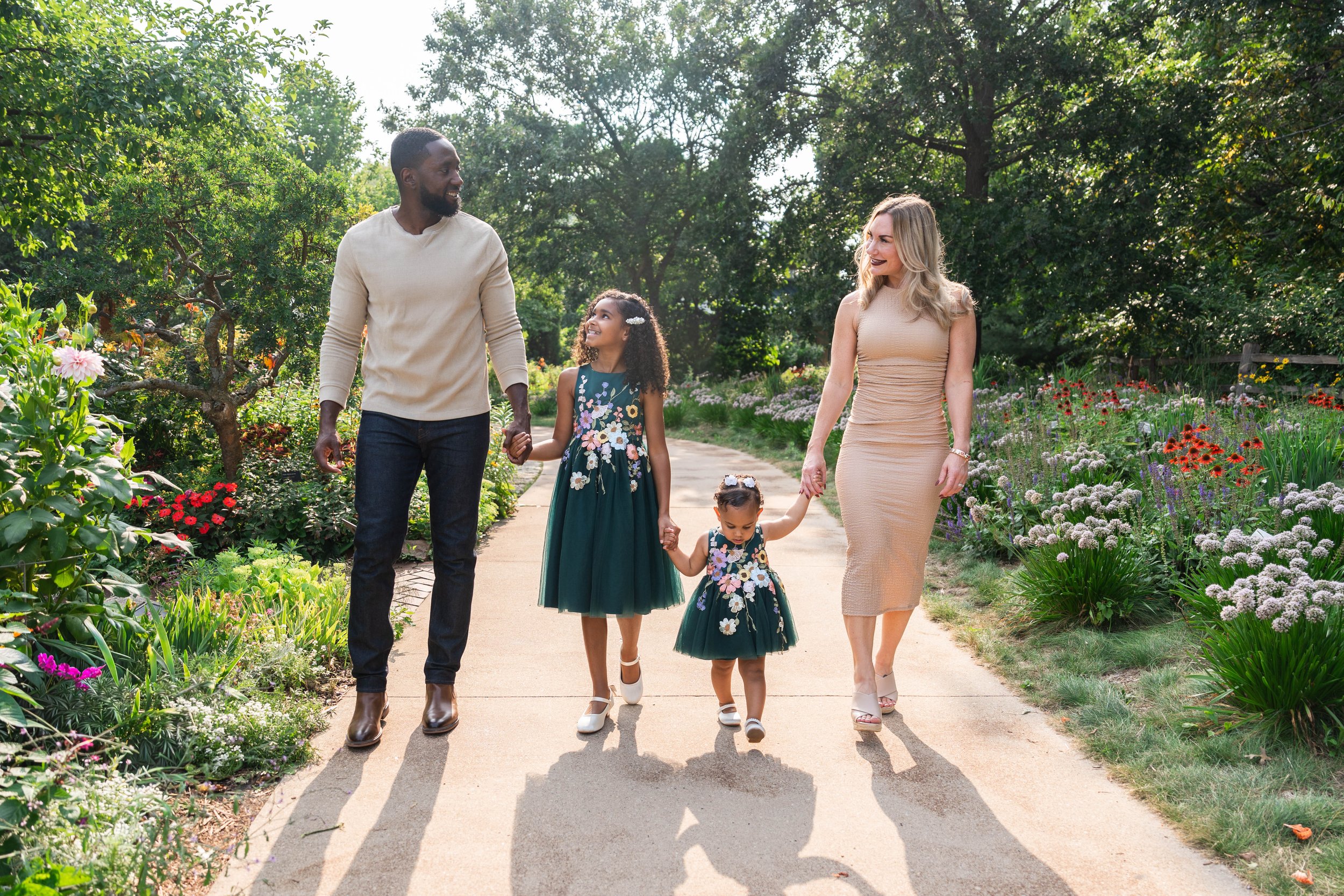 Multiracial family walking at Green Bay Botanical Gardens for family photos