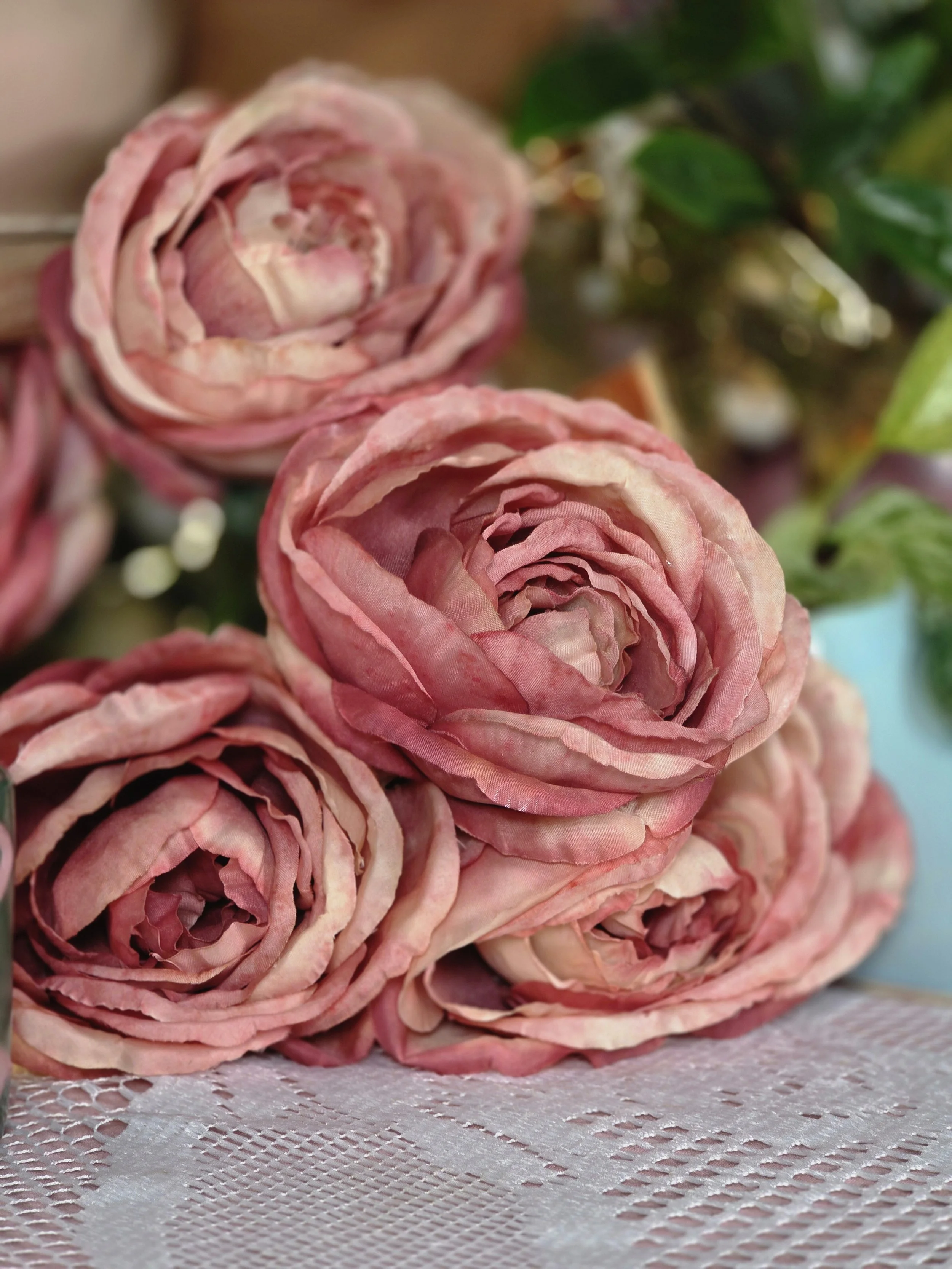 Soft blush pink roses resting on a lace table in a cozy, feminine Christian art studio, symbolizing beauty, gentleness, and creative rest.