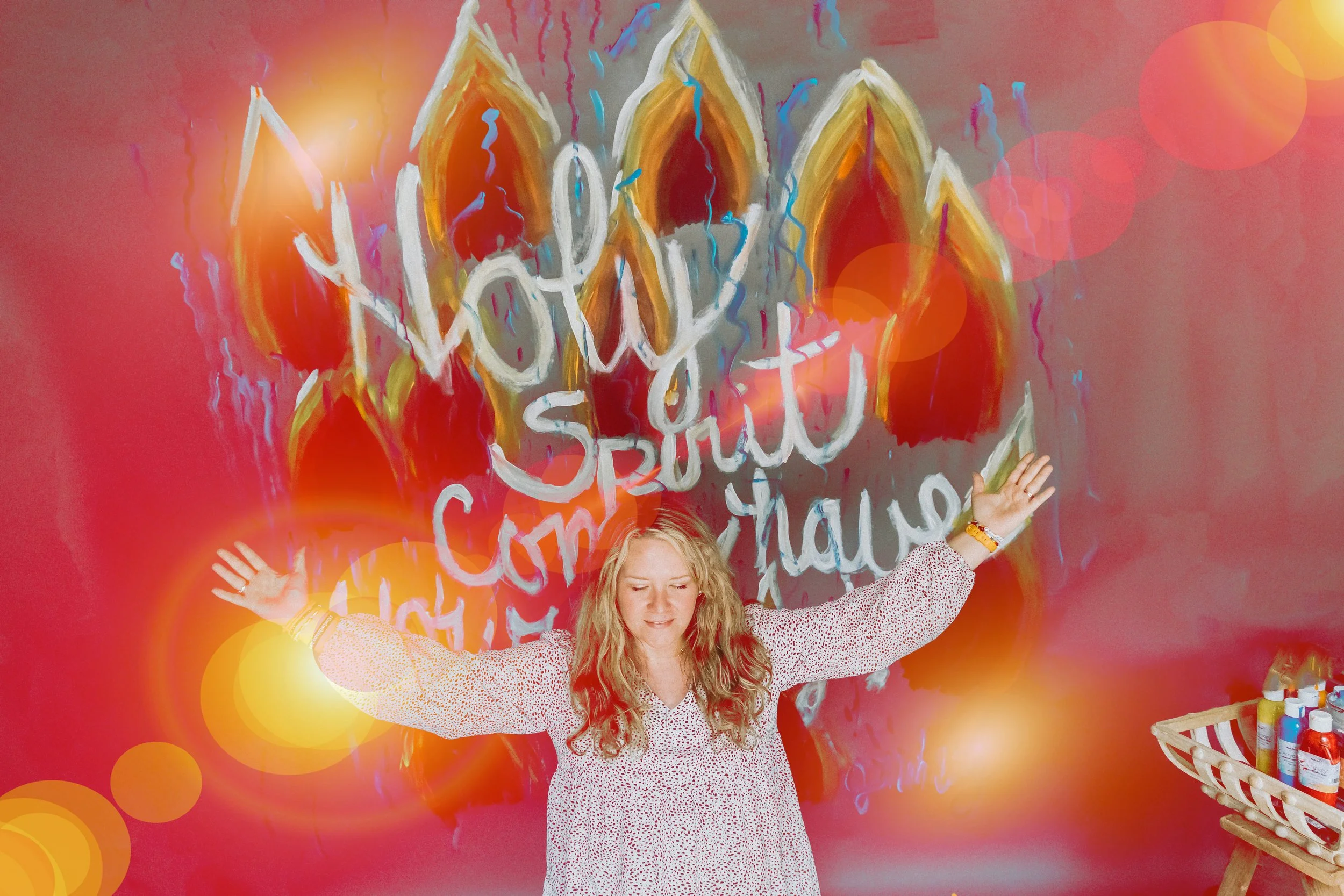 Jennifer Mehling kneeling in front of a painting that reads “Holy Spirit Come,” featuring bold colors and expressive brush strokes symbolizing spiritual depth and surrender.