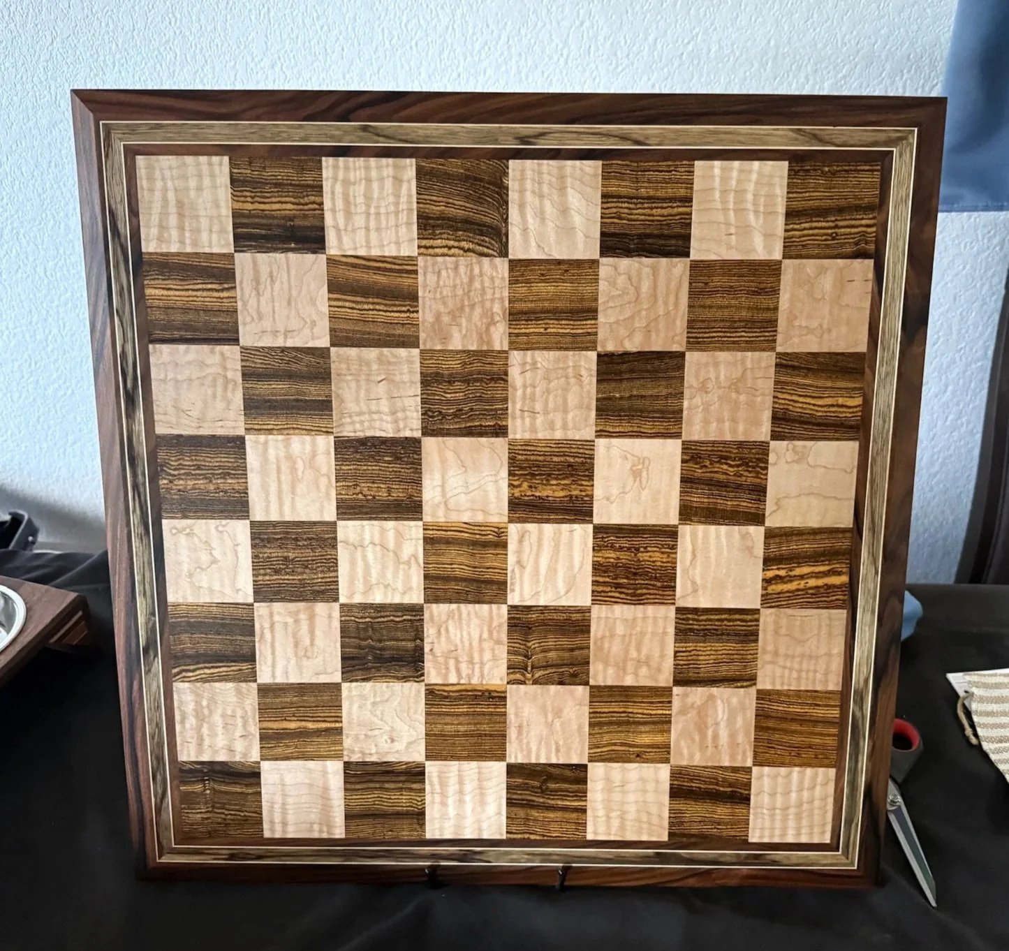 Tournament sized Chess Board made from Exotic Hardwoods including Bolivian Rosewood, Bocote, Black Limba, and also includes Flamed Maple for both the light squares and border accents.