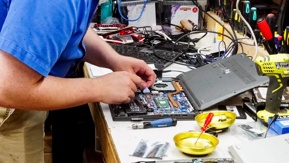 Technician repairing a laptop