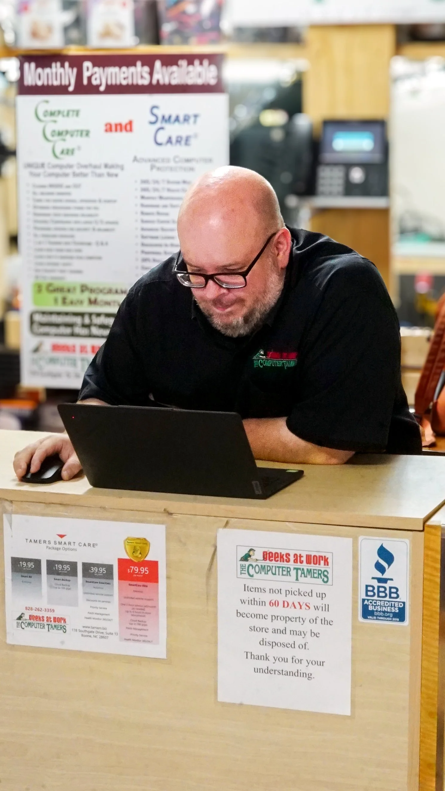 Computer Tamers team member working at the front counter
