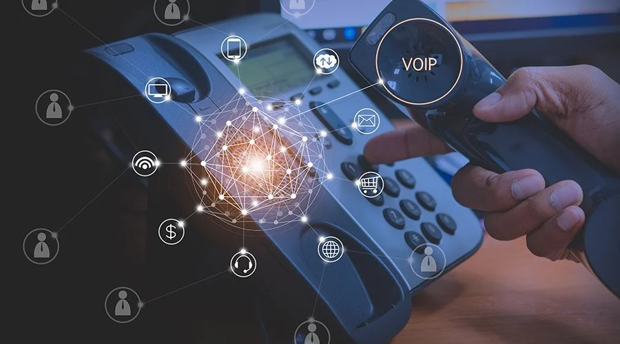 Hand using a VoIP desk phone