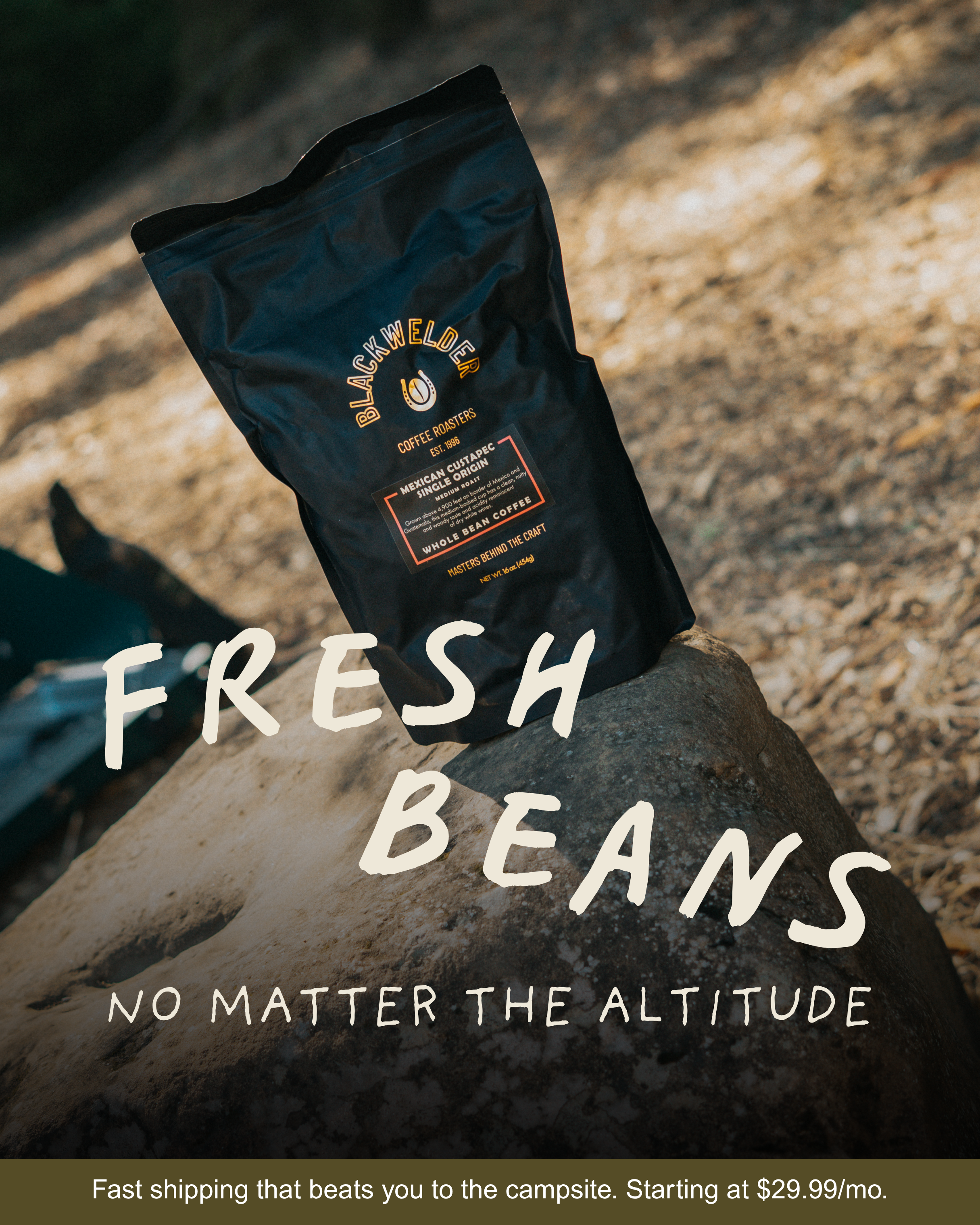 A black bag of Black Welder coffee roast placed on rock surface outdoors with a blurred natural background. White text on the image reads 'FRESH & BEANS' and an inscription mentions no matter the altitude.