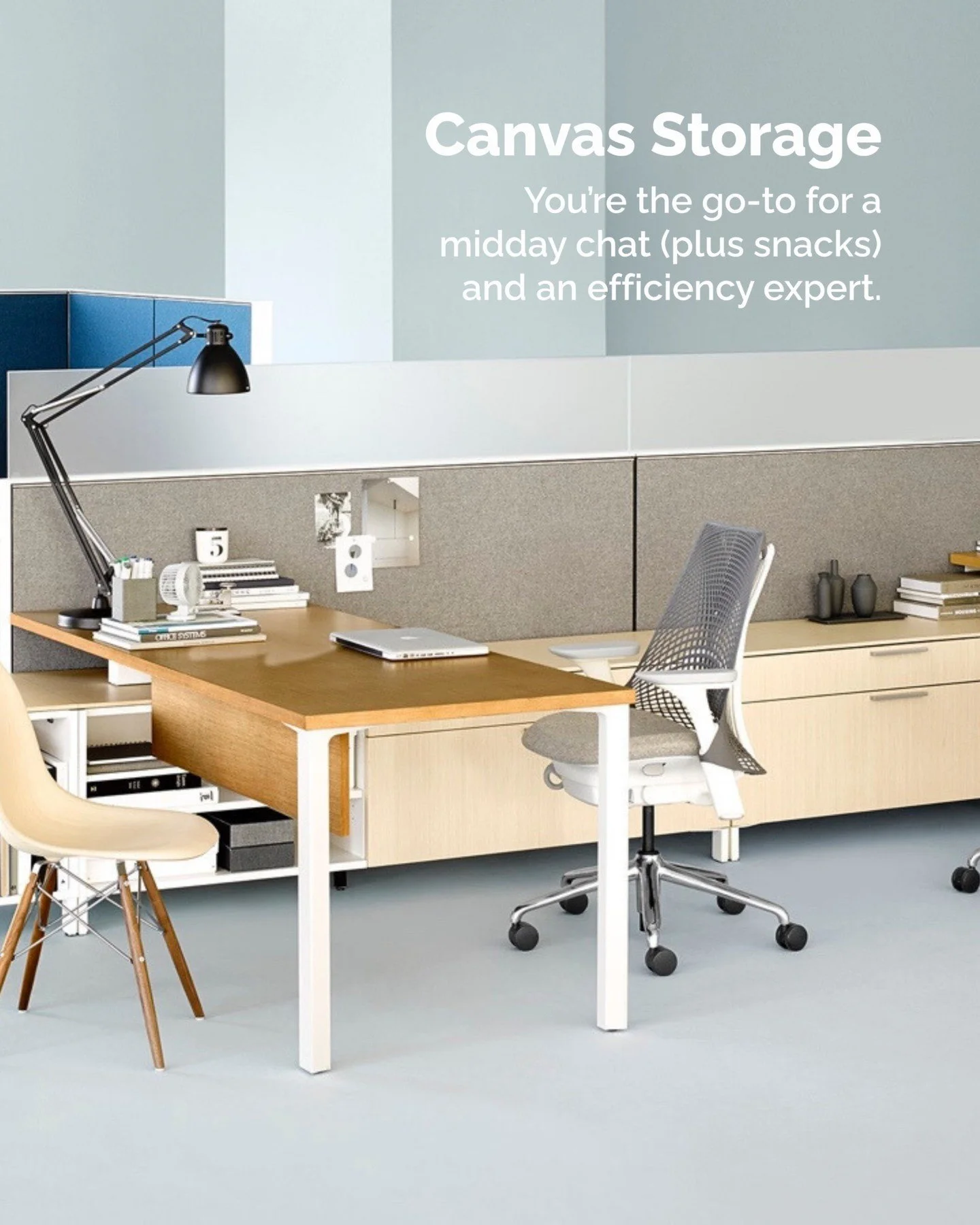 Interior of an office space with a wooden desk, a white ergonomic office chair, a black desk lamp, and office supplies. Behind the desk is a beige storage cabinet with books and decorative objects. A wall with a sign reading 'Canvas Storage' and a description about midday chat and snacks.
