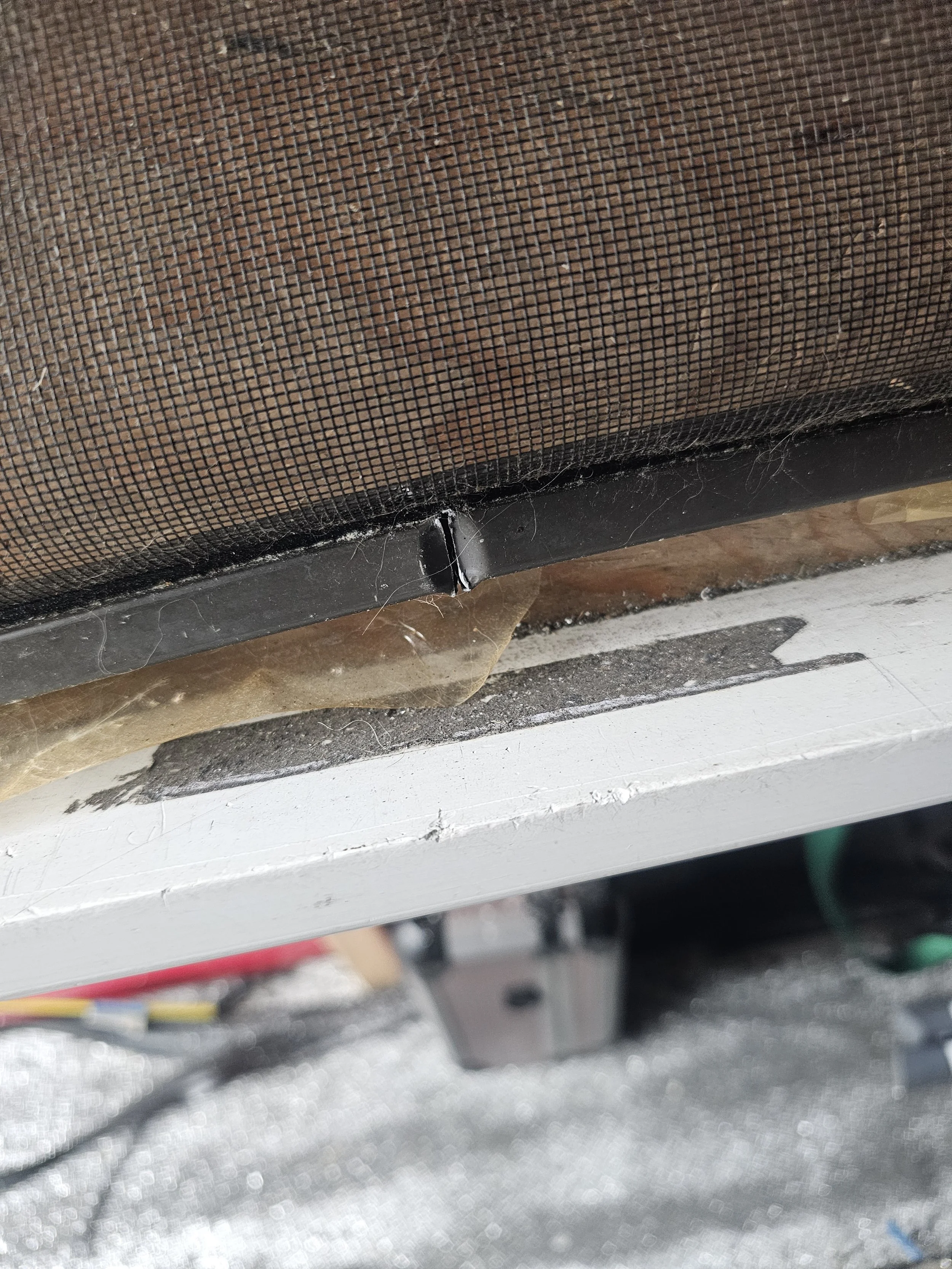 Damaged window screen frame.