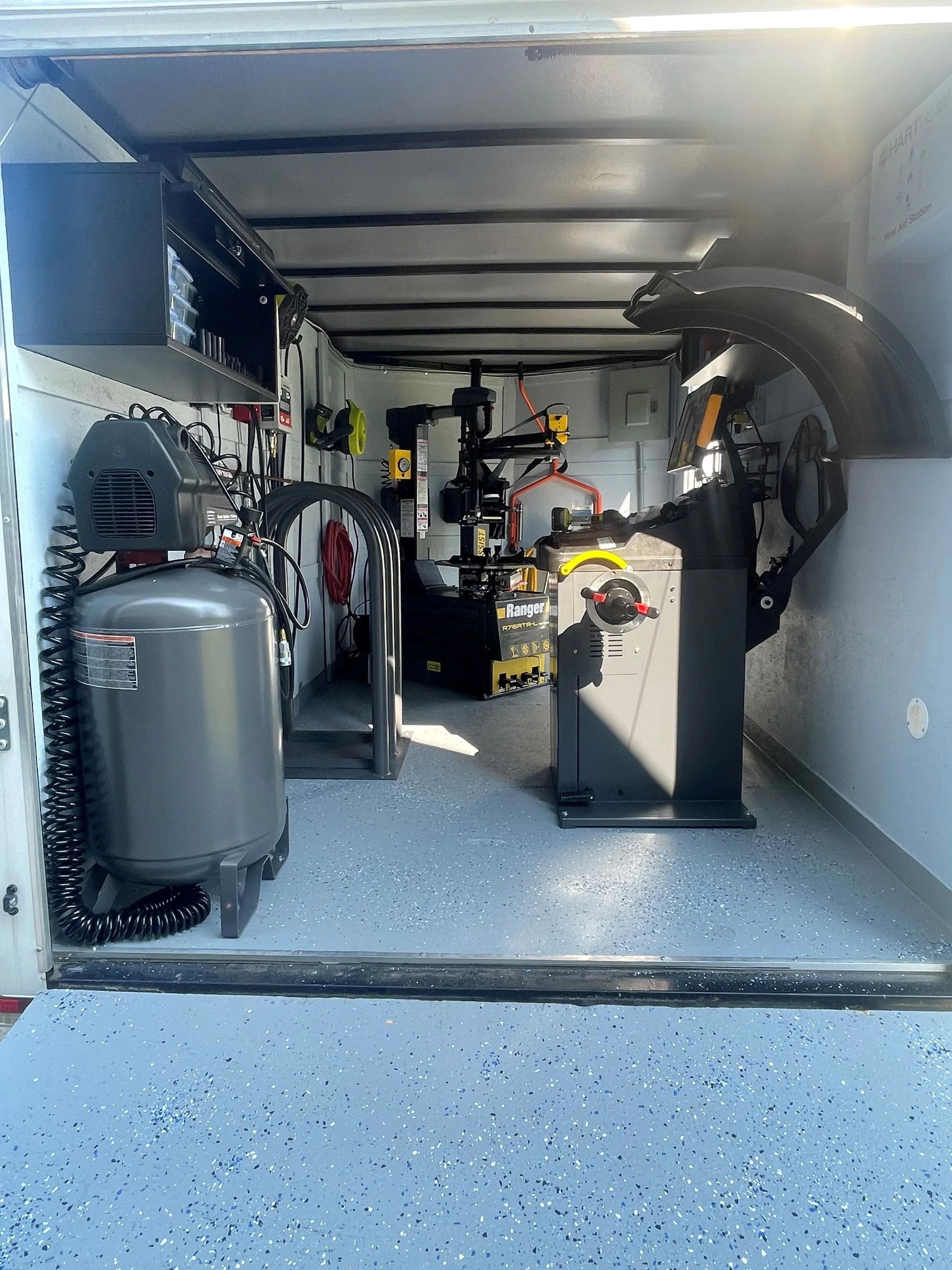 Inside a mobile workshop trailer with tools and equipment for tire replacement, tire repair, and tire service in Wilmington, NC
