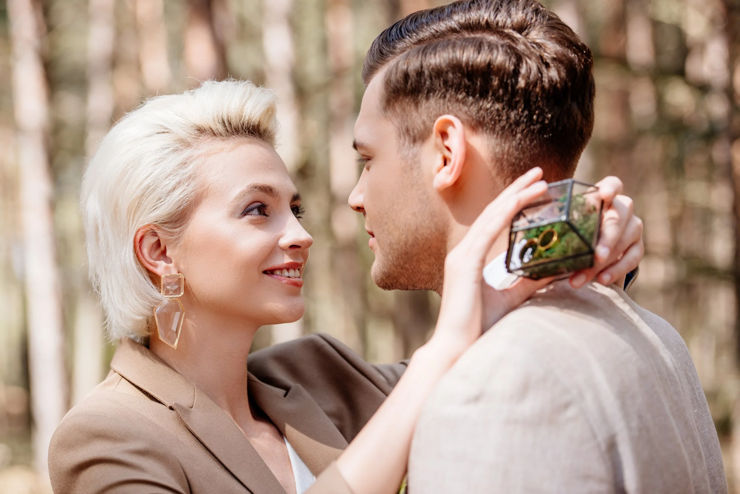 smiling-blonde-girl-holding-box-with-wedding-rings-2023-11-27-05-25-33-utc.jpg