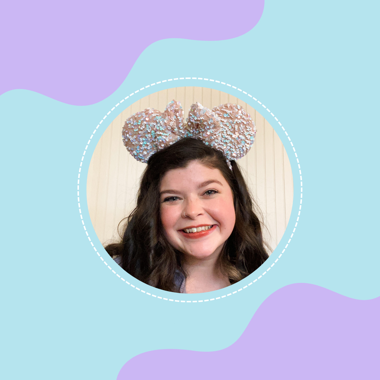 A young woman with long dark hair, smiling, wearing a large sequin bow headband with bear ears.