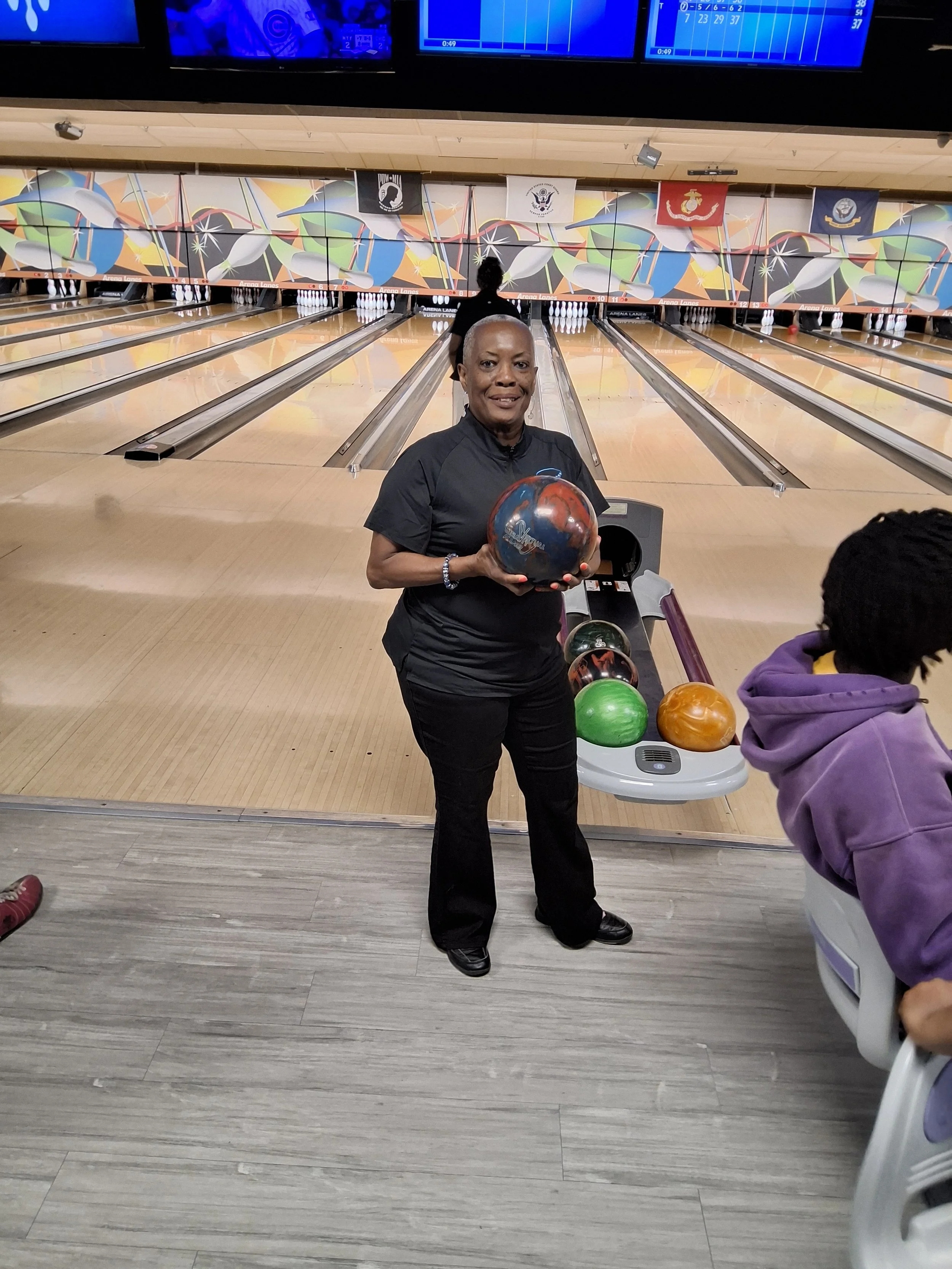A woman holding a bowling ball at BPEFI’s 2026 Bowling for Scholars fundraising event.