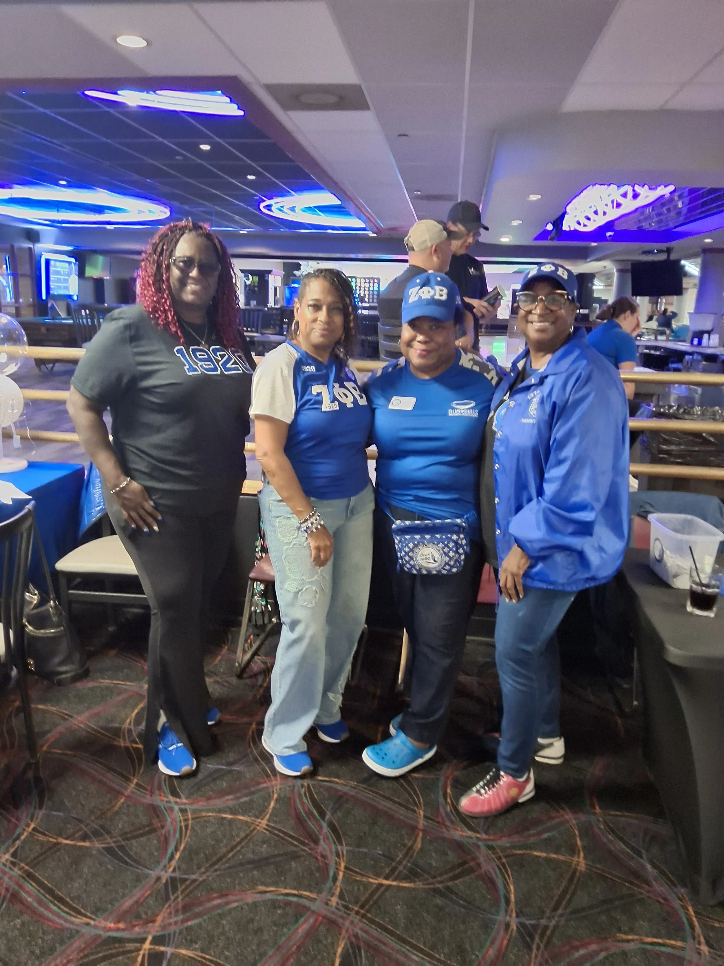 Four guests posing together at BPEFI’s 2026 Bowling for Scholars fundraising event.