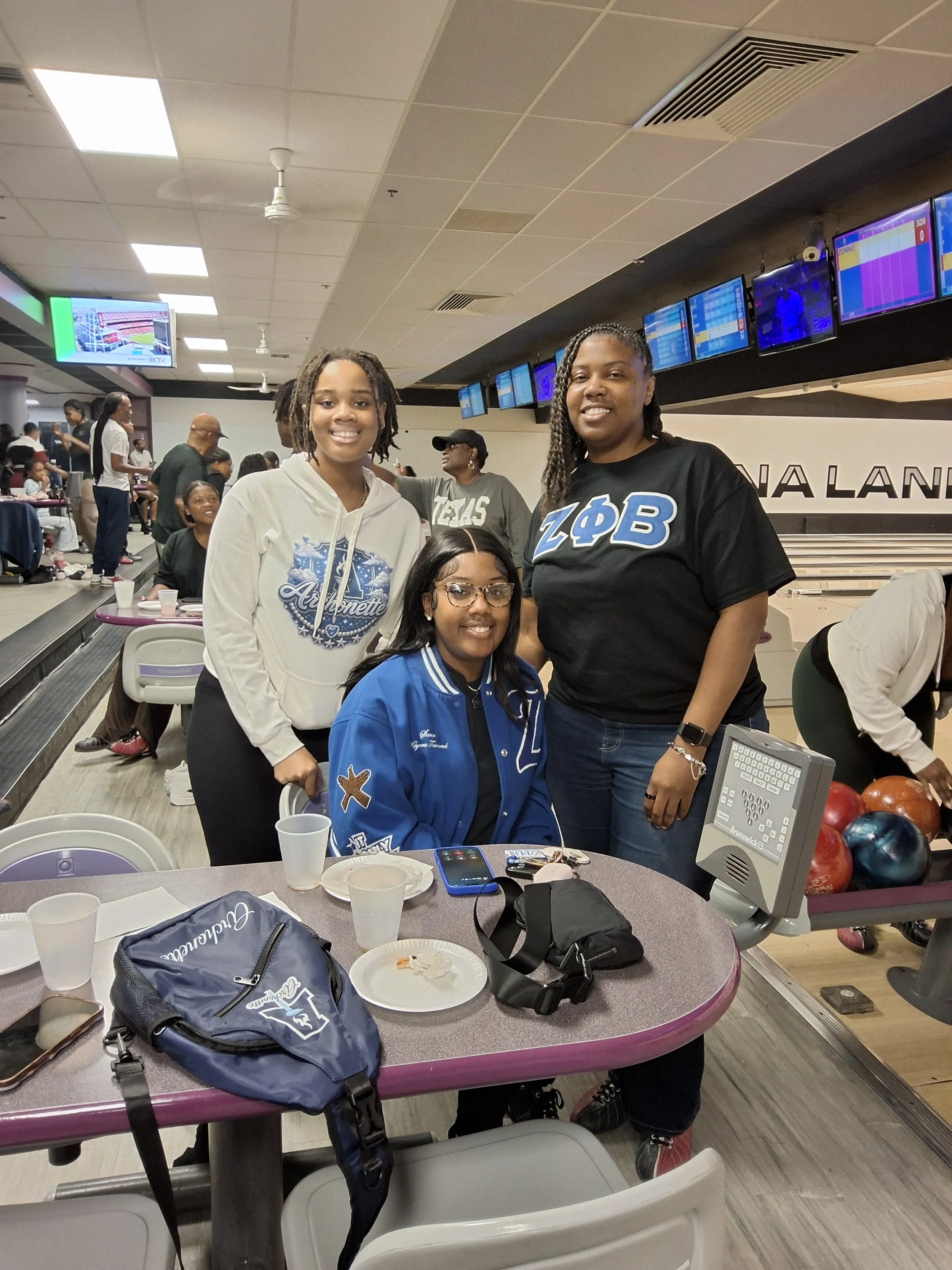 Guests gathered beside a table at BPEFI’s 2026 Bowling for Scholars fundraising event.