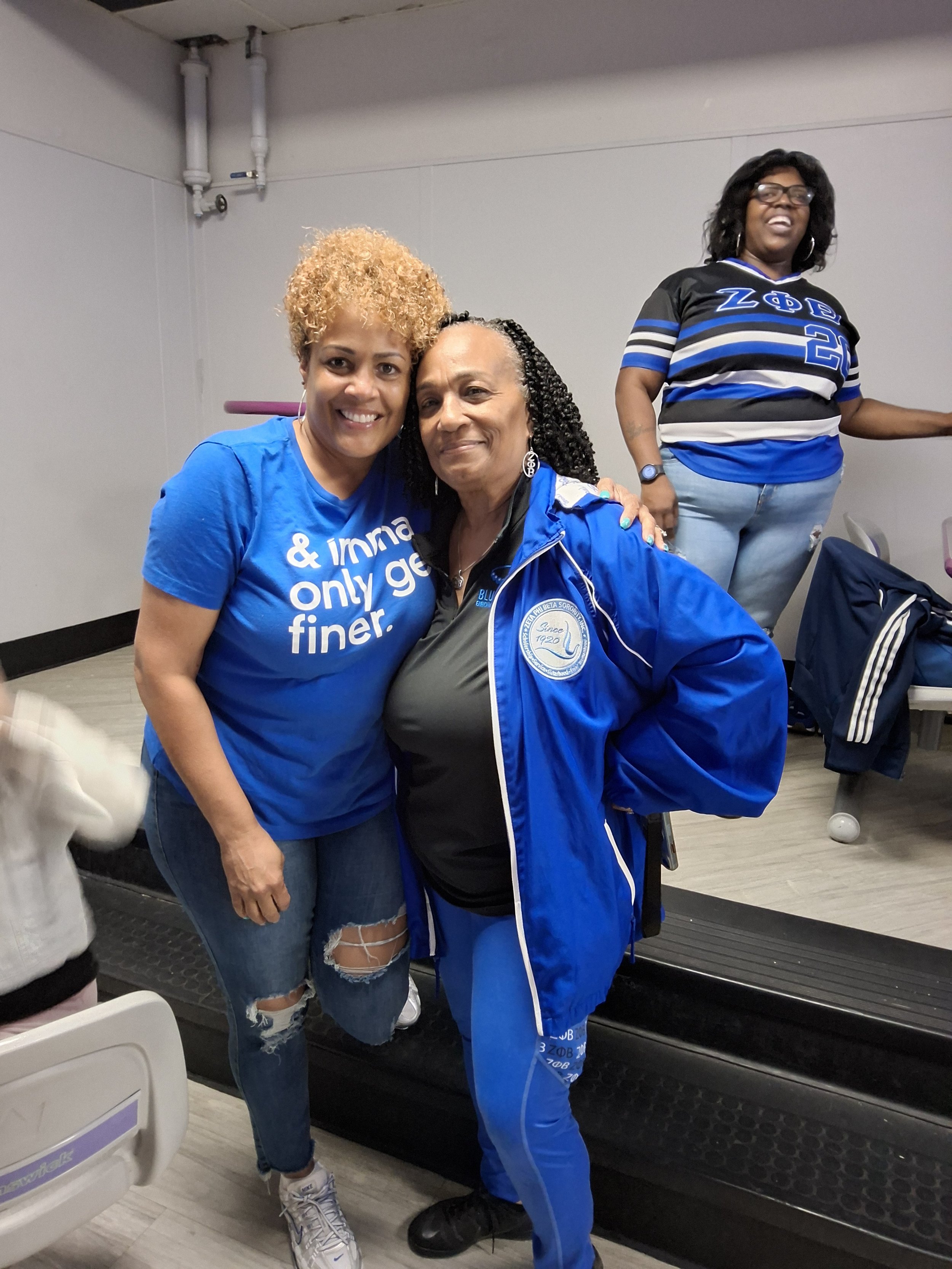 Three women smiling together at BPEFI’s 2026 Bowling for Scholars fundraising event.