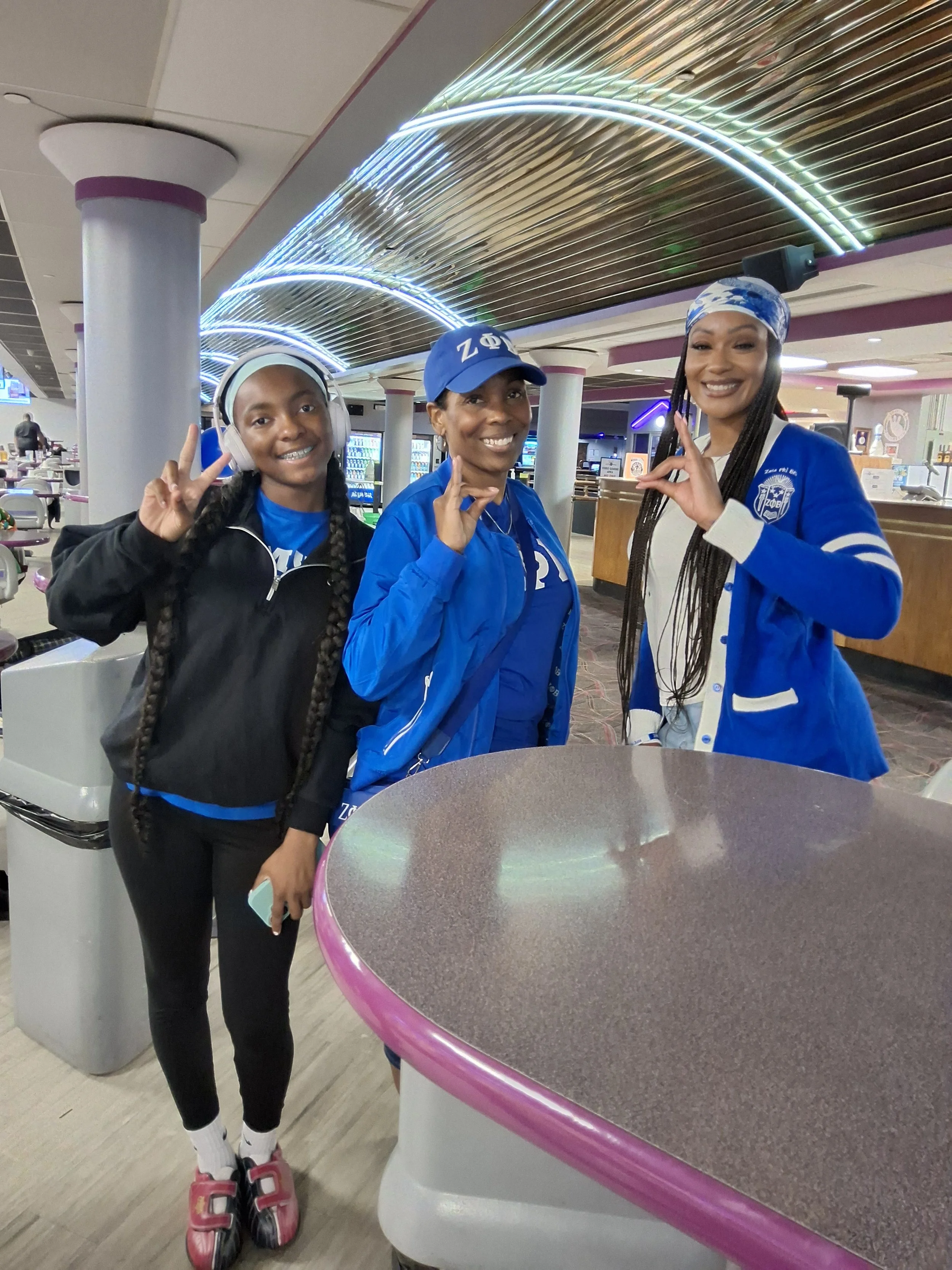 Three women posing together at BPEFI’s 2026 Bowling for Scholars fundraising event.