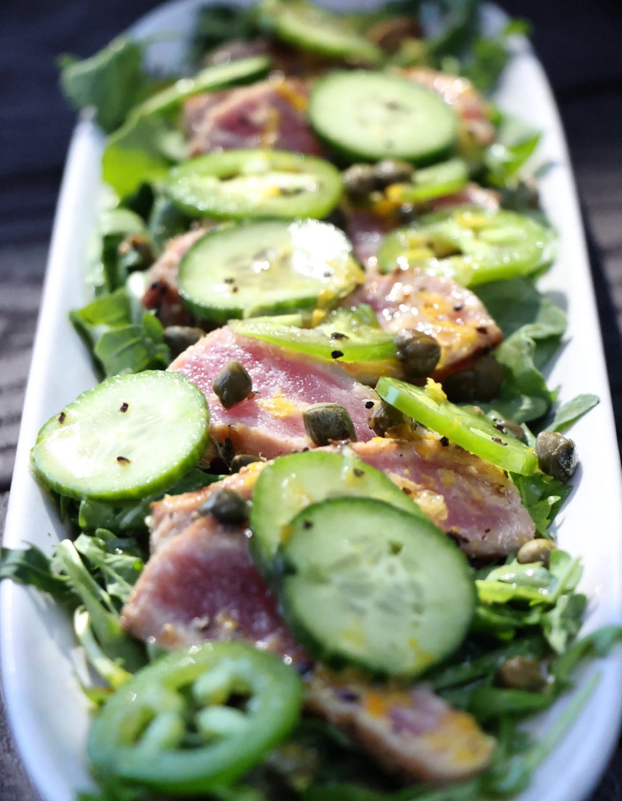 🐟 Meet our newest addition: Seared Ahi Tuna Crudo.

🥗 Enjoy lightly seared ahi over a bed of fresh arugula, crunchy Persian cucumbers, and jalape&ntilde;os, drizzled with a tangy house caper-citrus vinaigrette.

✨ It&rsquo;s perfect for a solo bite