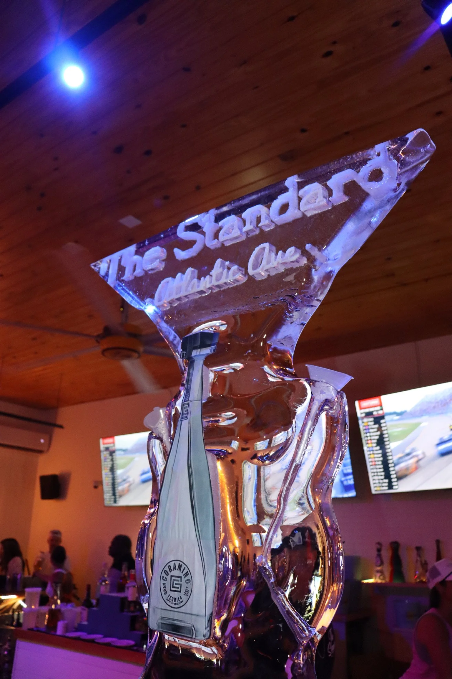 Ice sculpture display with champagne bottle at Standard Delray Beach restaurant lounge