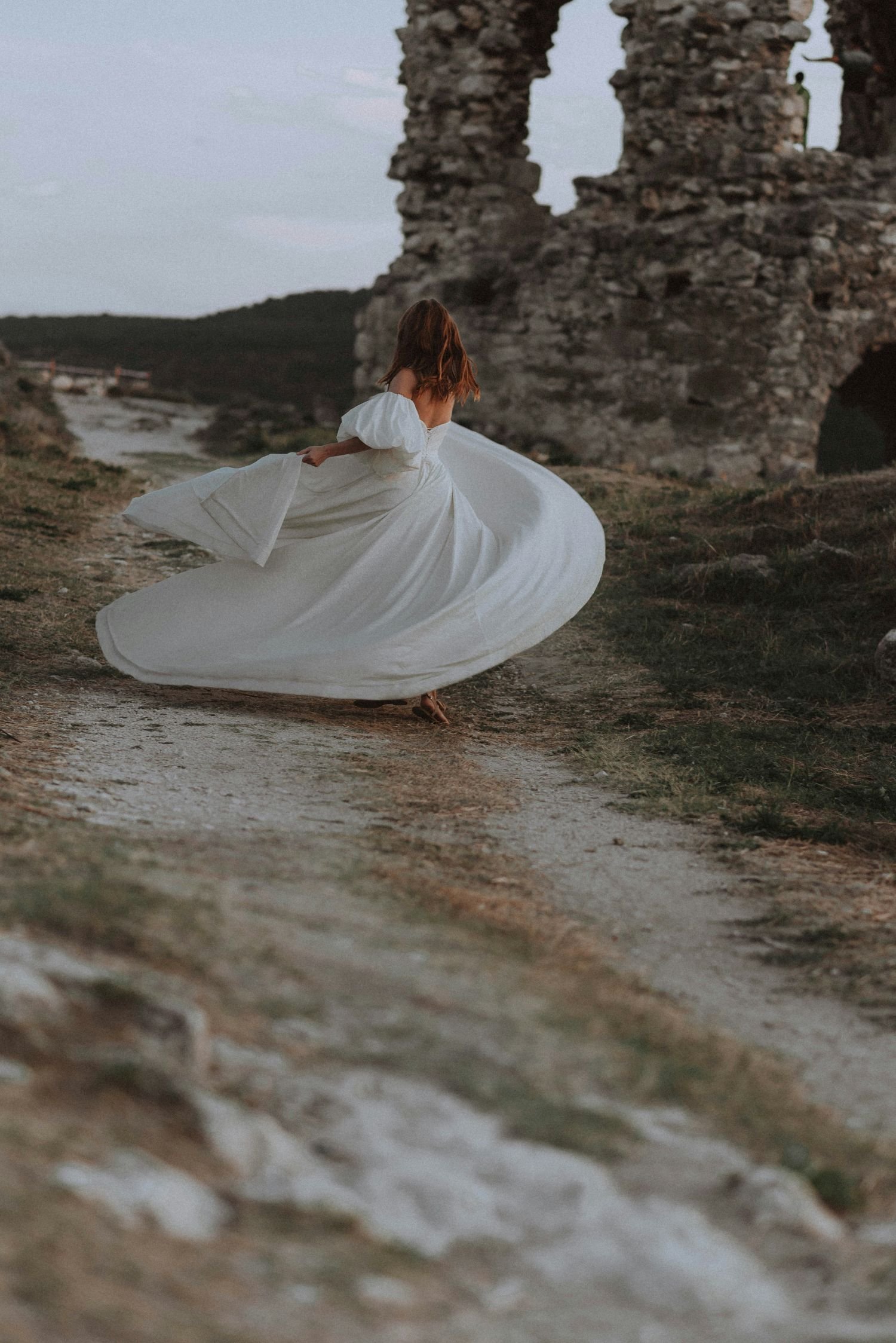 A bride twirling around in her dress