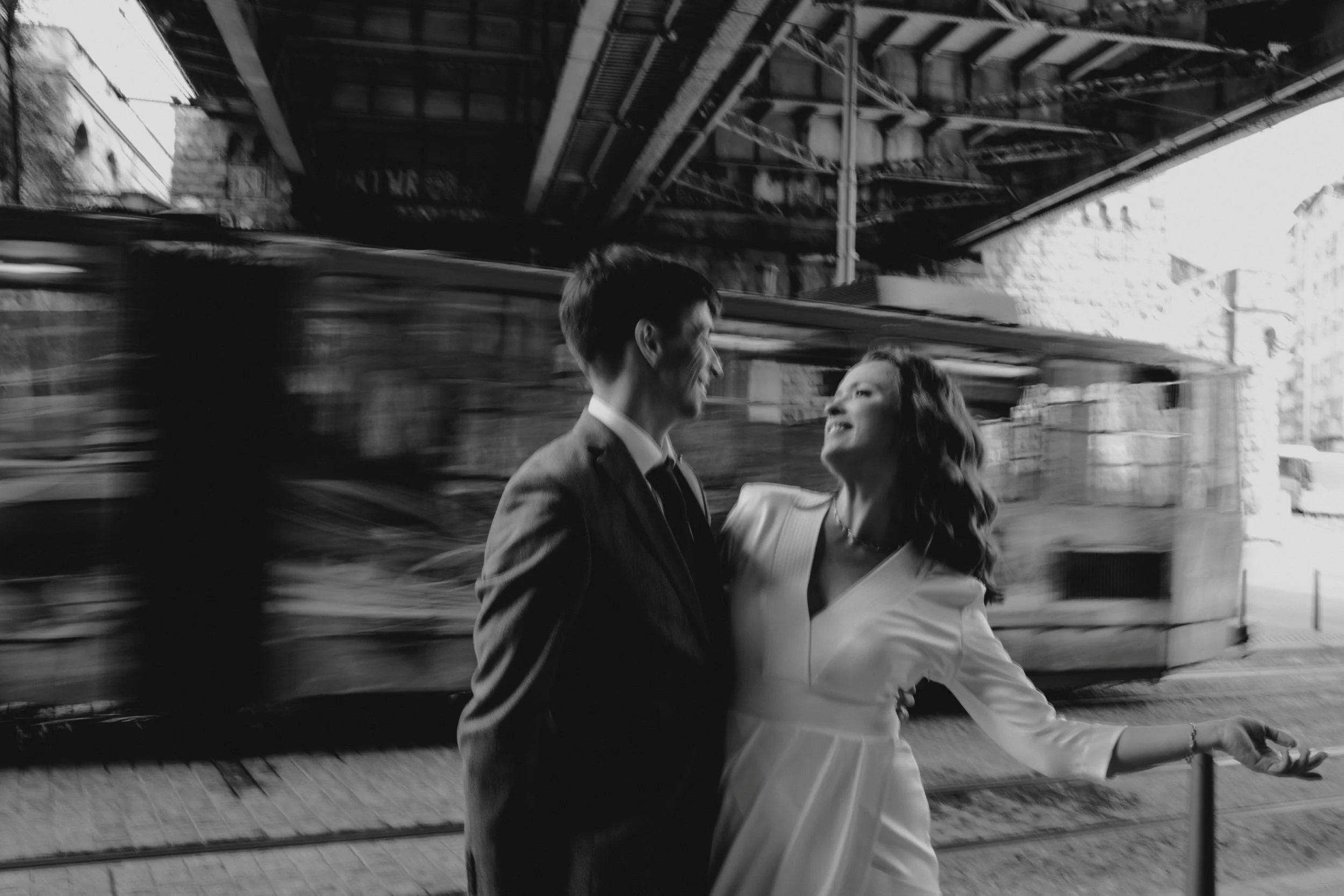 Wedding couple in front of train in the city