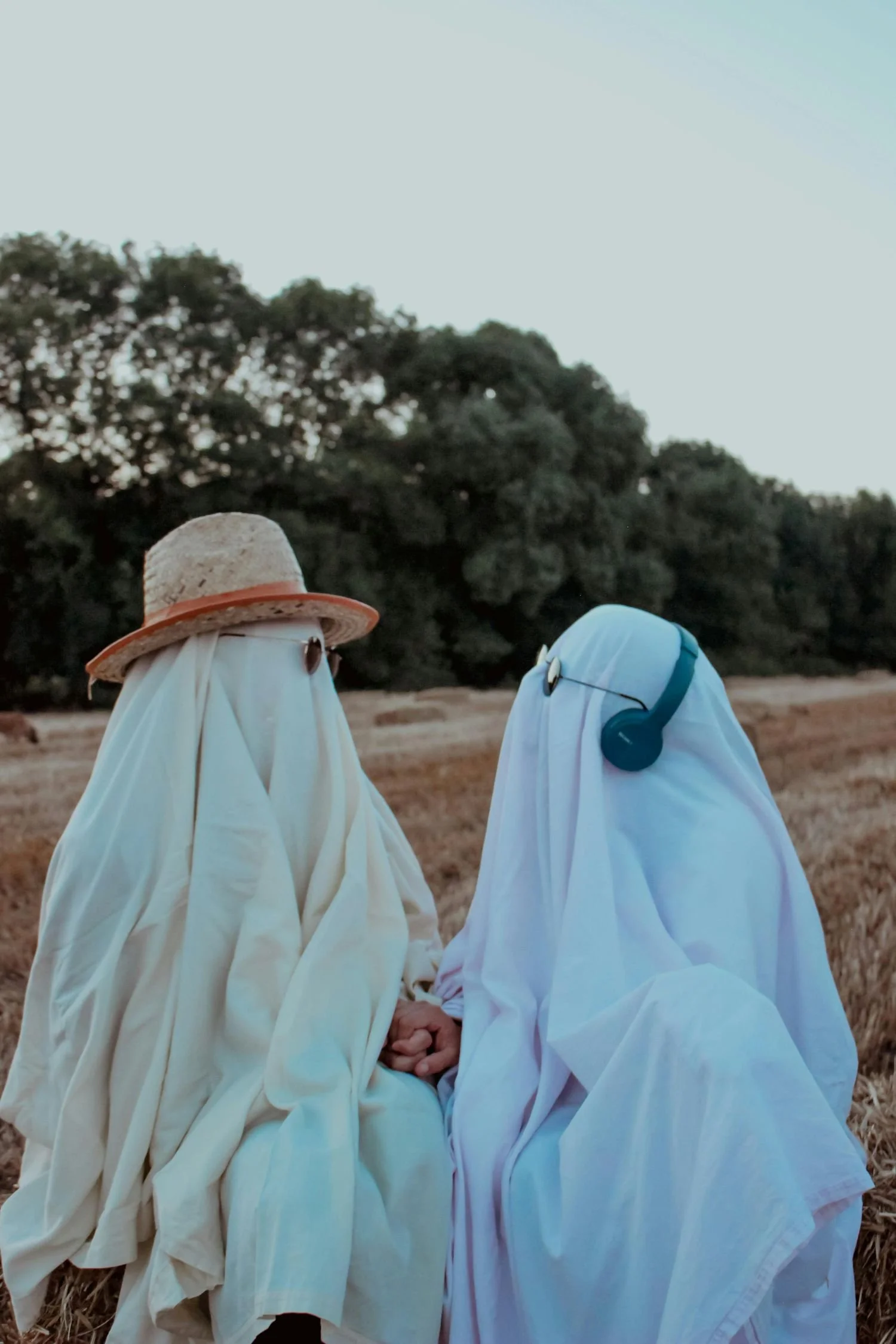 A couple dressed as ghosts staring lovingly at each other