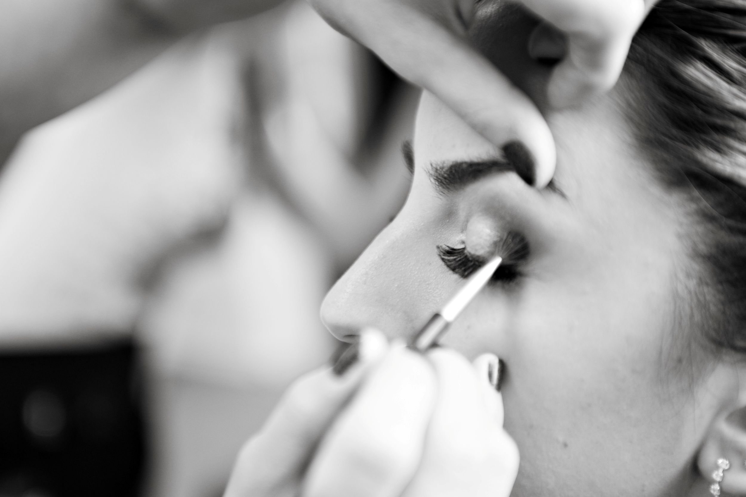 Bridal makeup artist applying eyeshadow to a bridesmaid