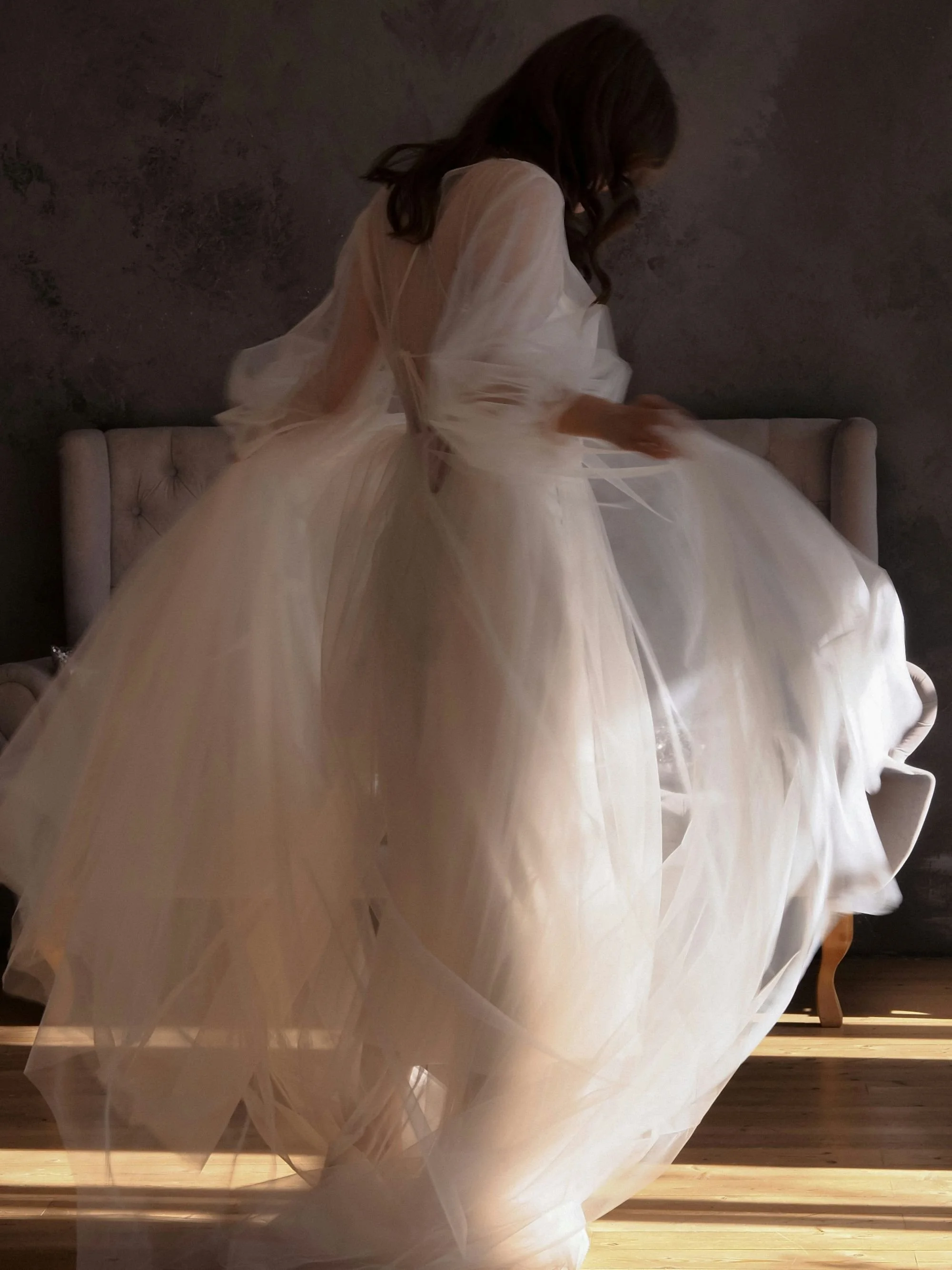 A bride twirling around in her tulle wedding dress