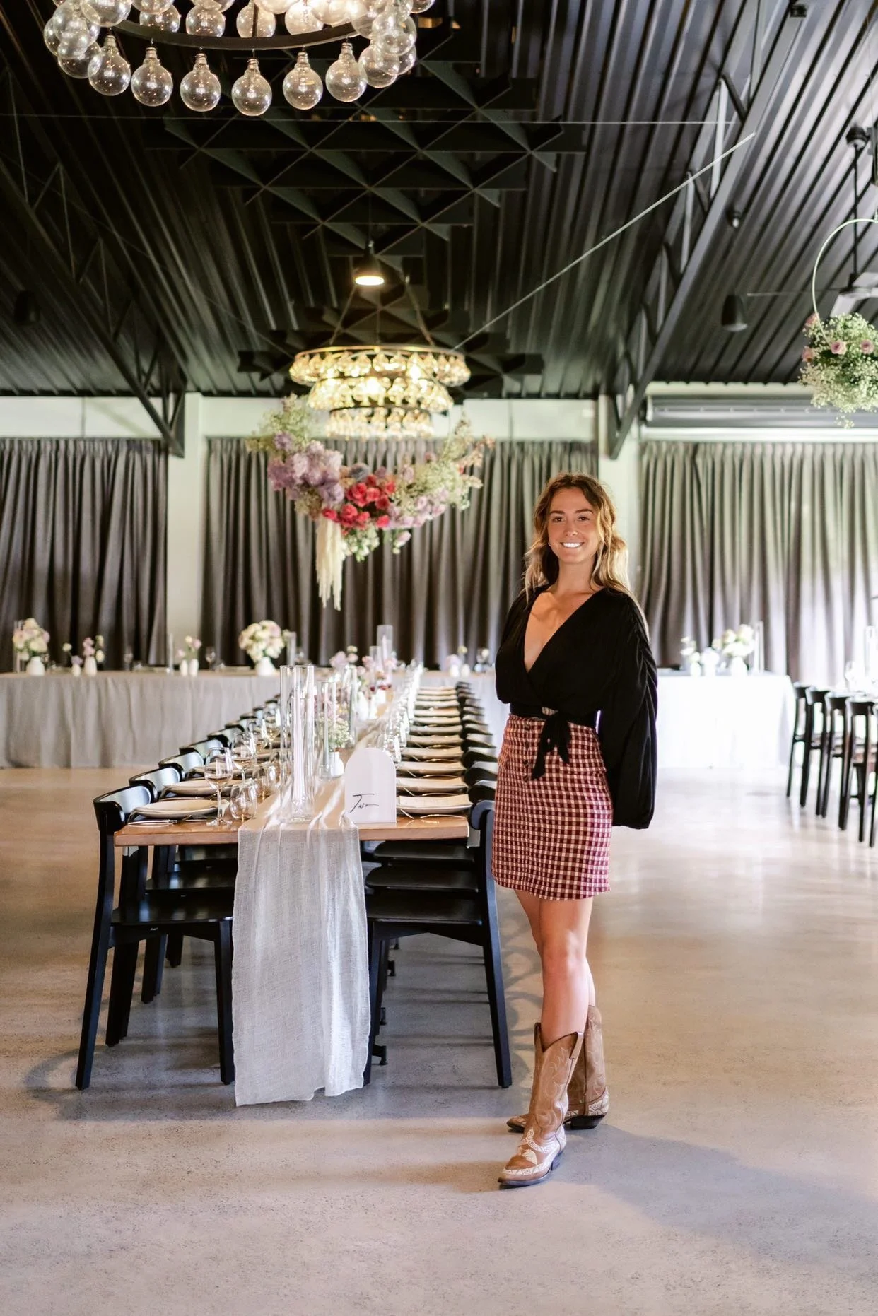 Wedding stylist Kenny McCrae standing in front of a table set for a large wedding