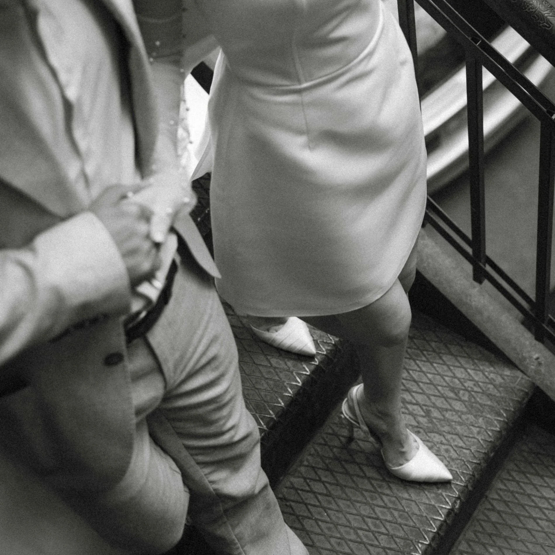 A bride and groom walking down stairs