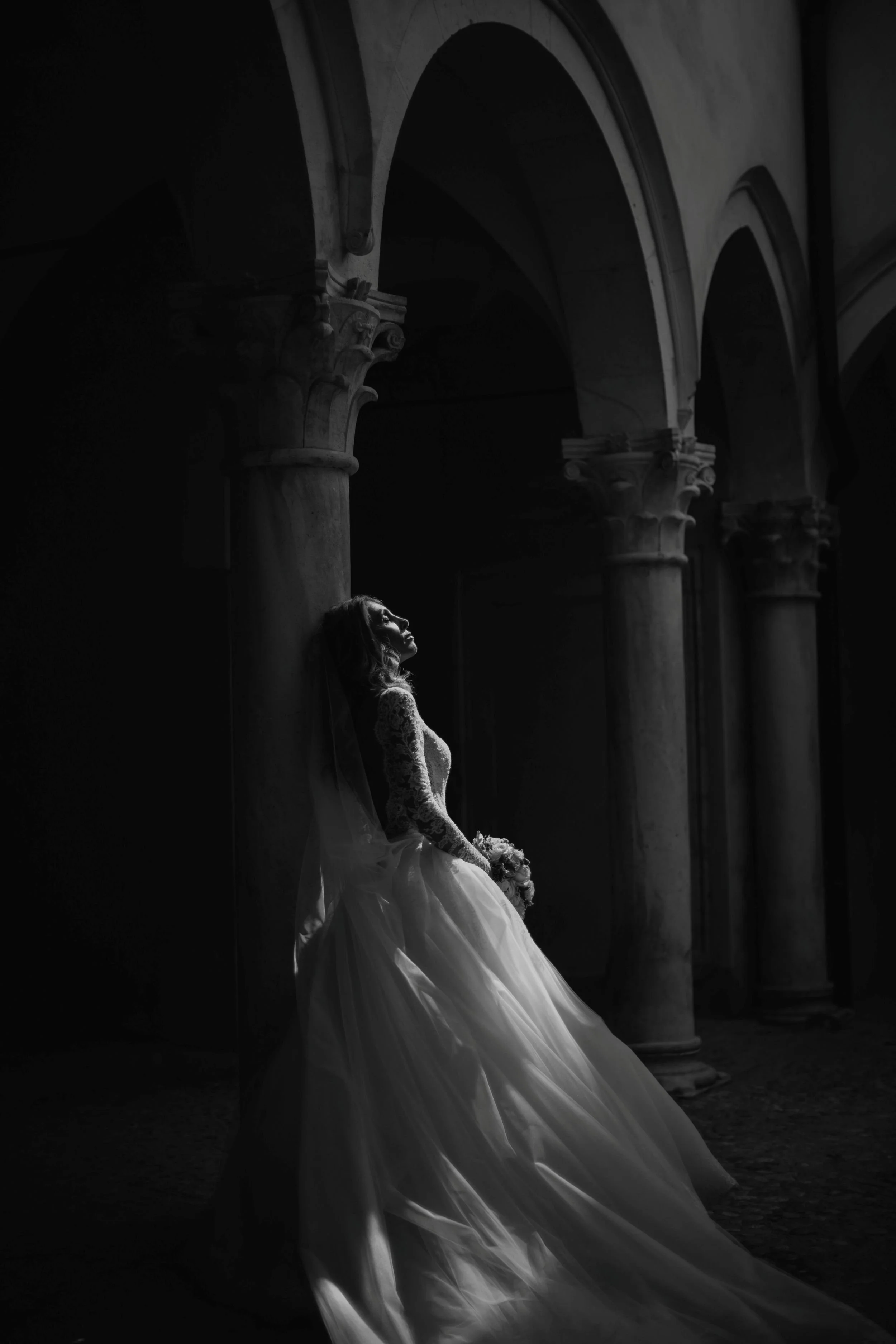 Bride taking a moment in a grand building