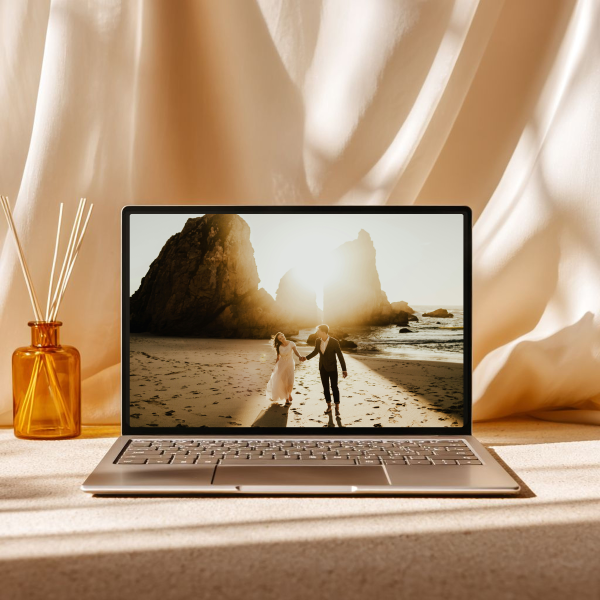 A laptop displaying a wedding photographers website