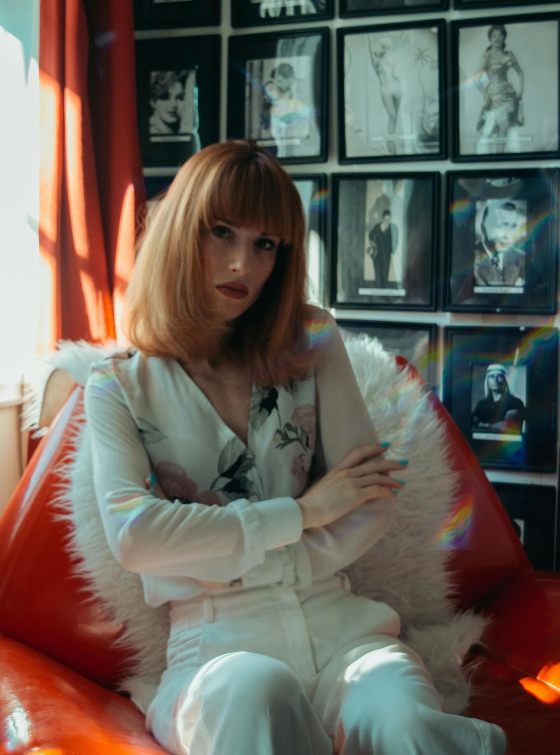 Woman dressed in white sitting in an orange chair