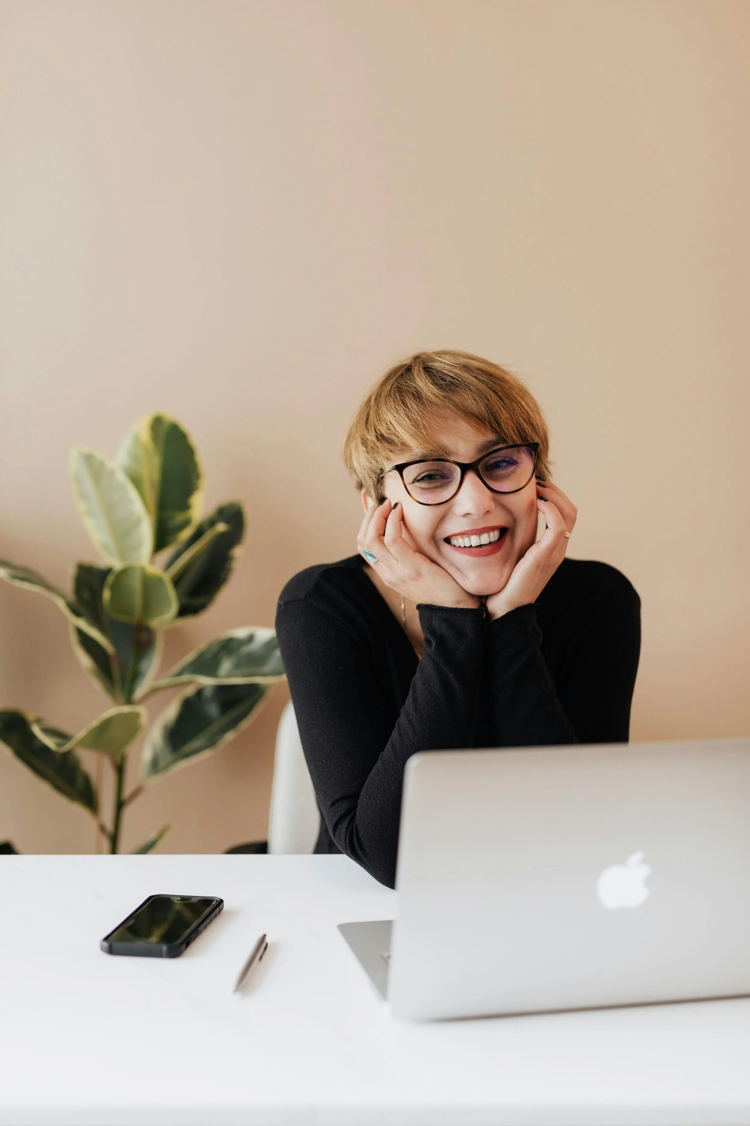 Wedding vendor smiling next to her laptop