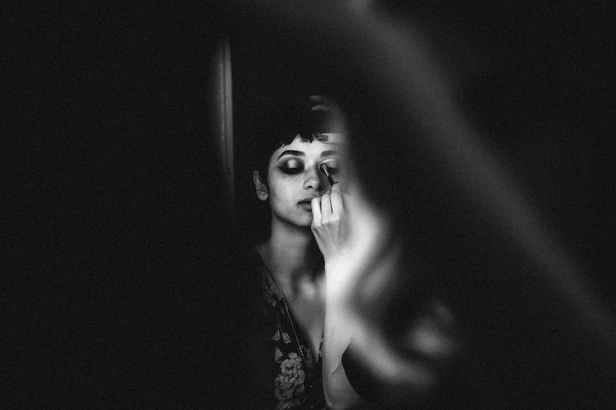 Bridal makeup artist applying make to a woman