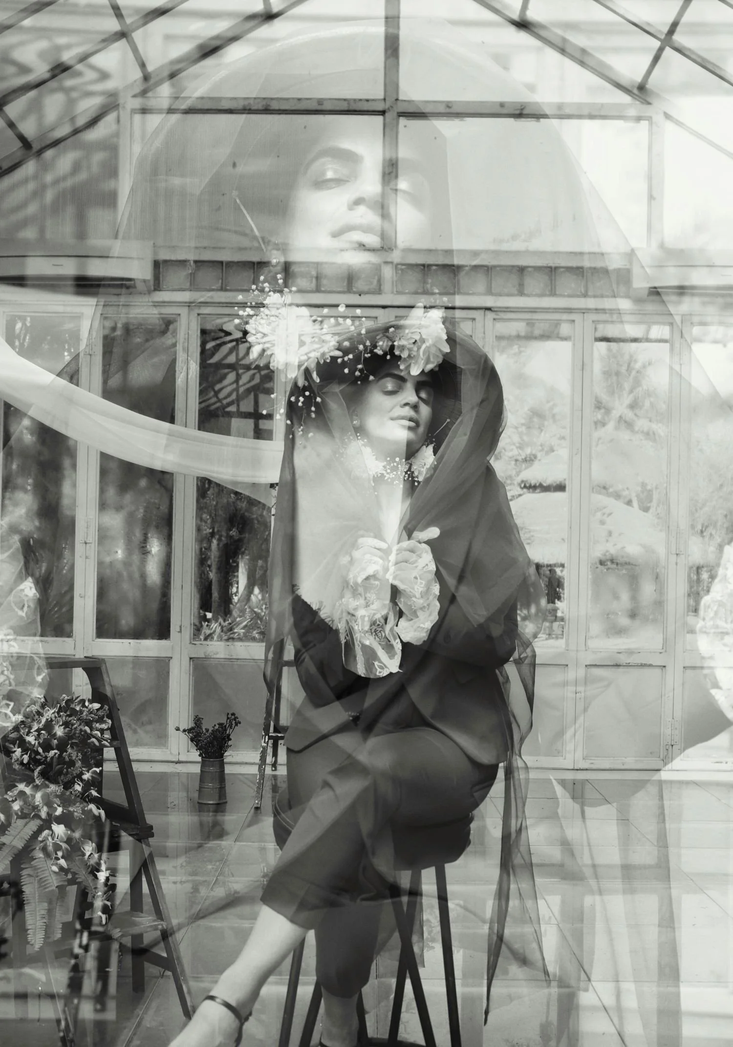 A beautiful woman sitting on a stool in a studio