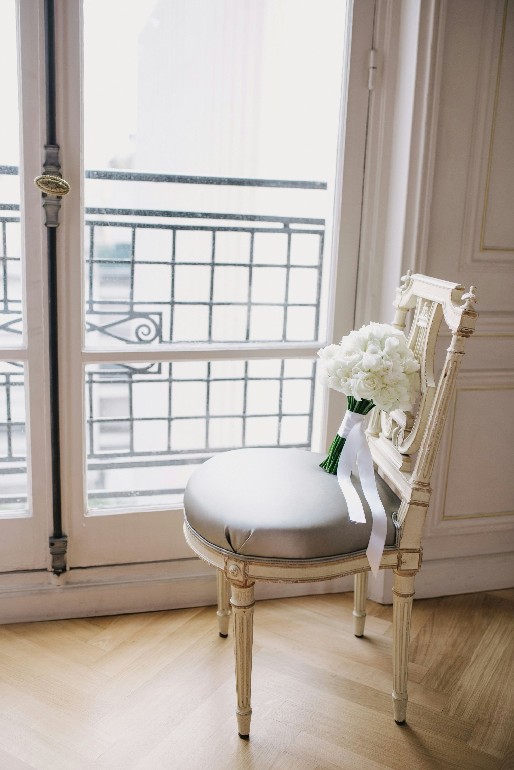 Bridal bouquet sitting on a vintage chair