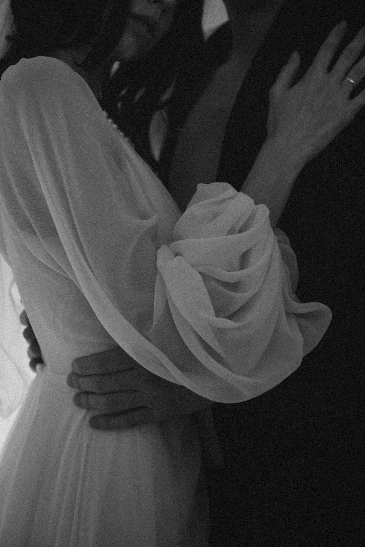 A wedding couple holding each other