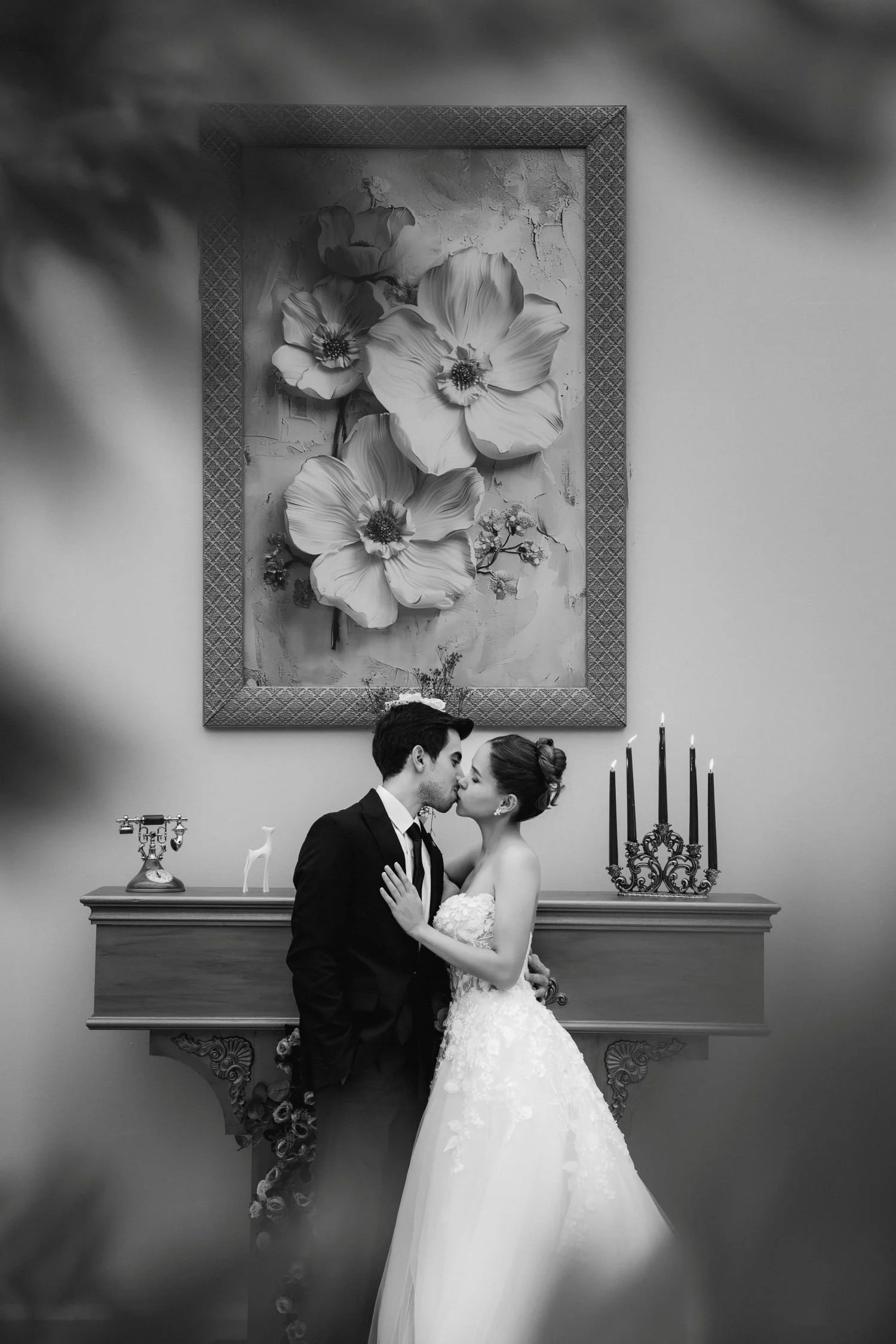 A wedding couple kissing in a beautiful vintage hallway.