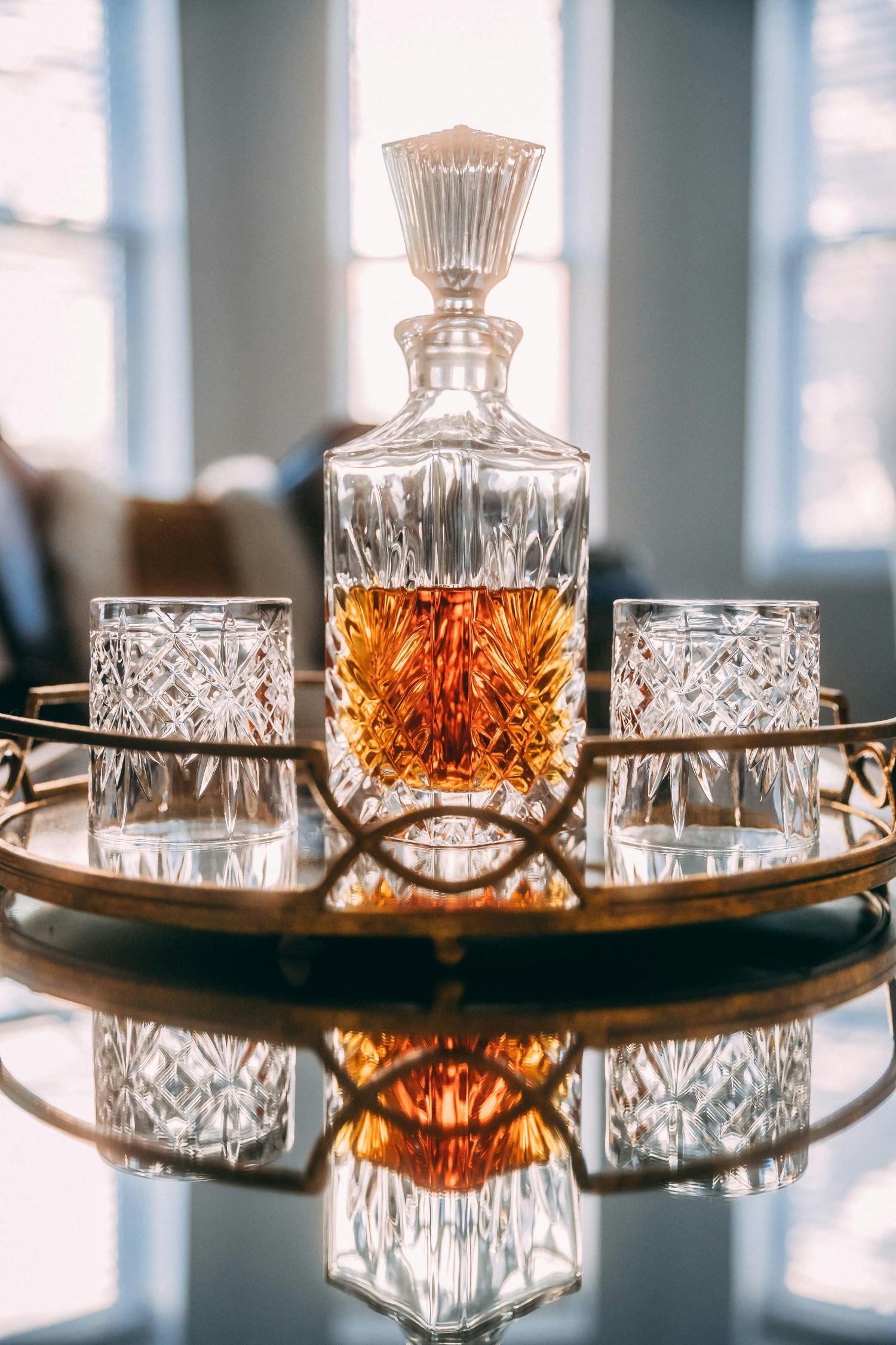 Whiskey in a crystal decanter with two crystal low balls