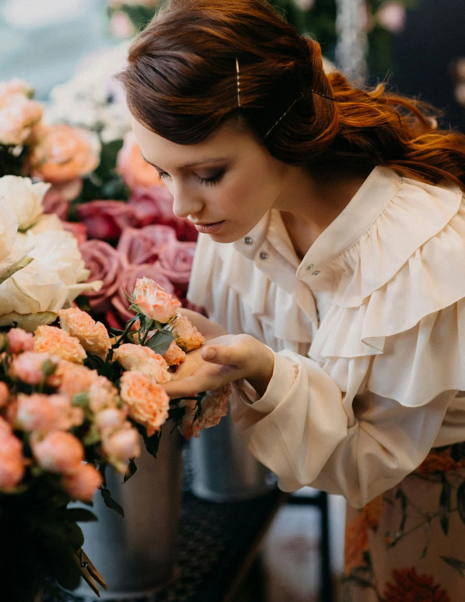 A wedding florist smelling organic flowers