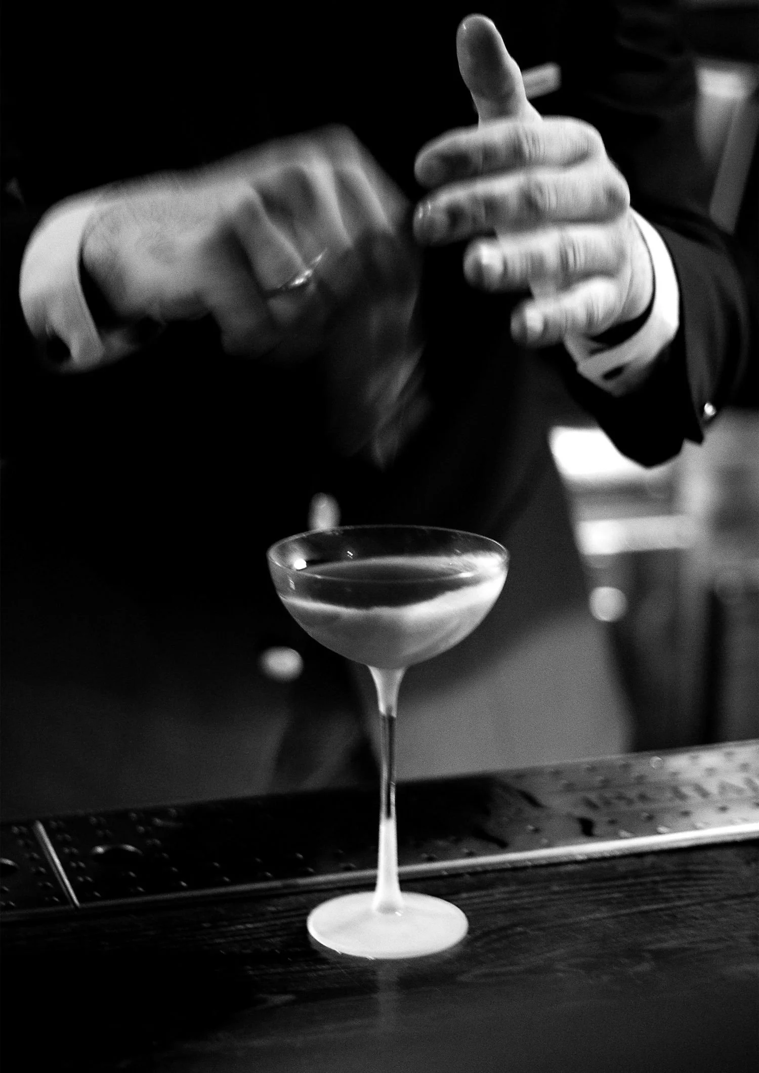 Groom mixing up a cocktail on the bar