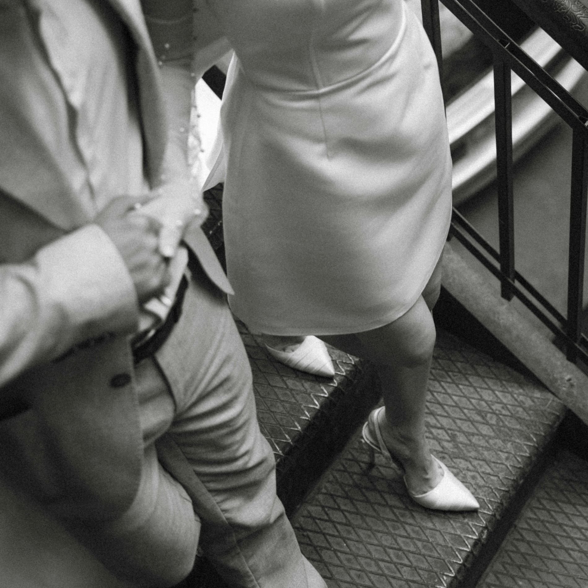 Wedding couple walking down stairs together