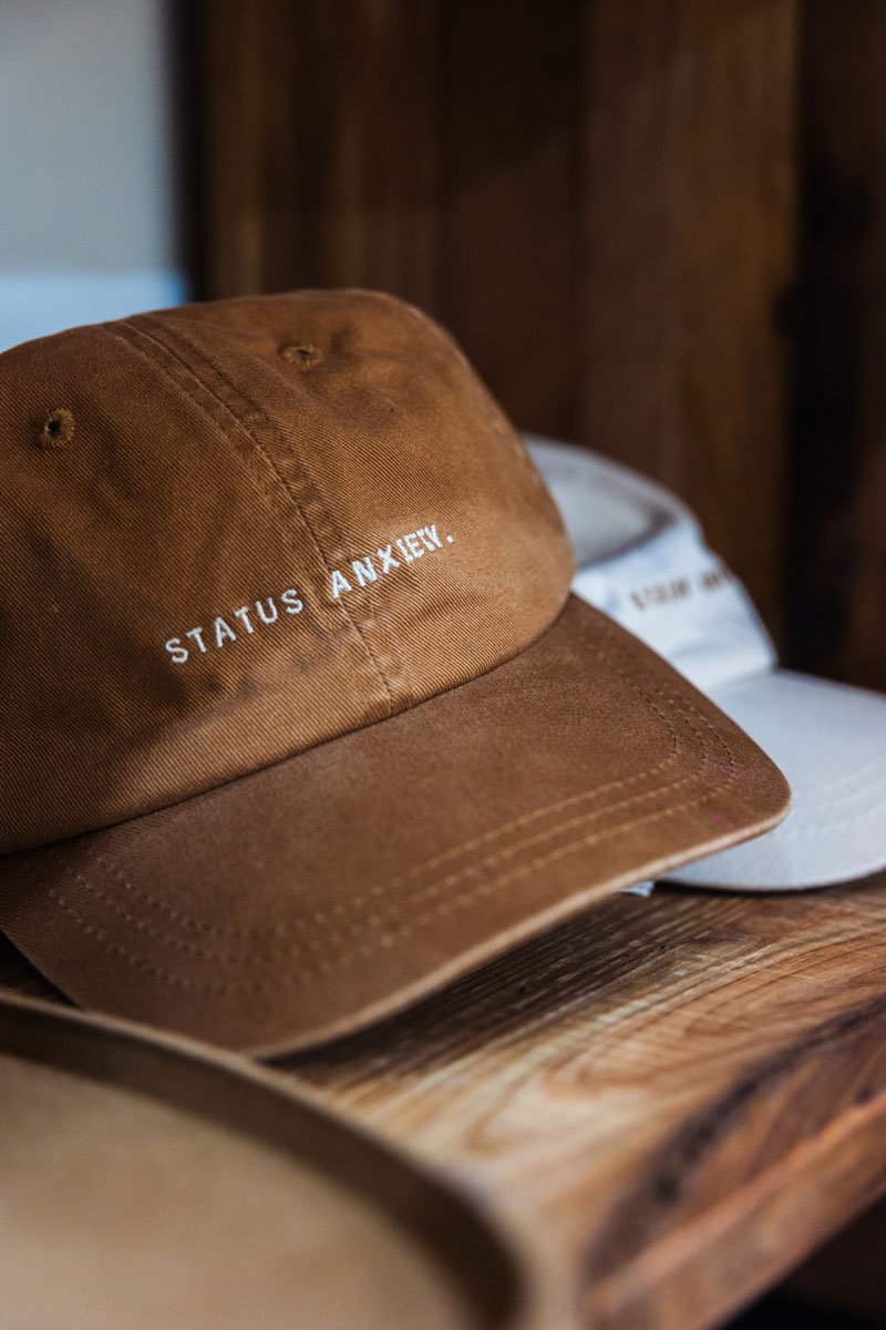 Two caps on a wooden shelf