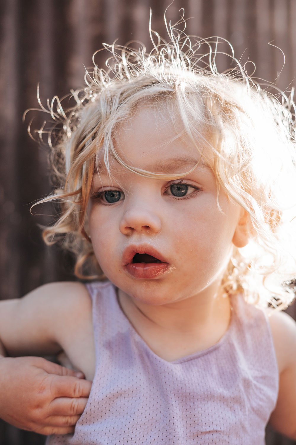 Cute boy toddler with big eyes and messy, long blonde hair