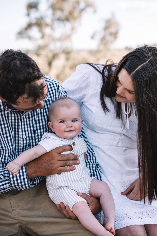 Young couple with smiling baby