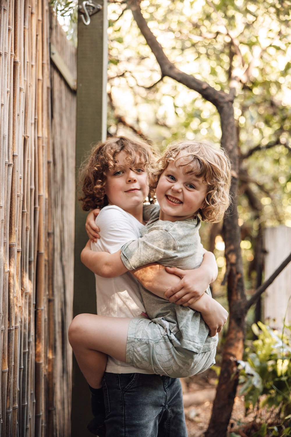 Two young boys cuddling and playing