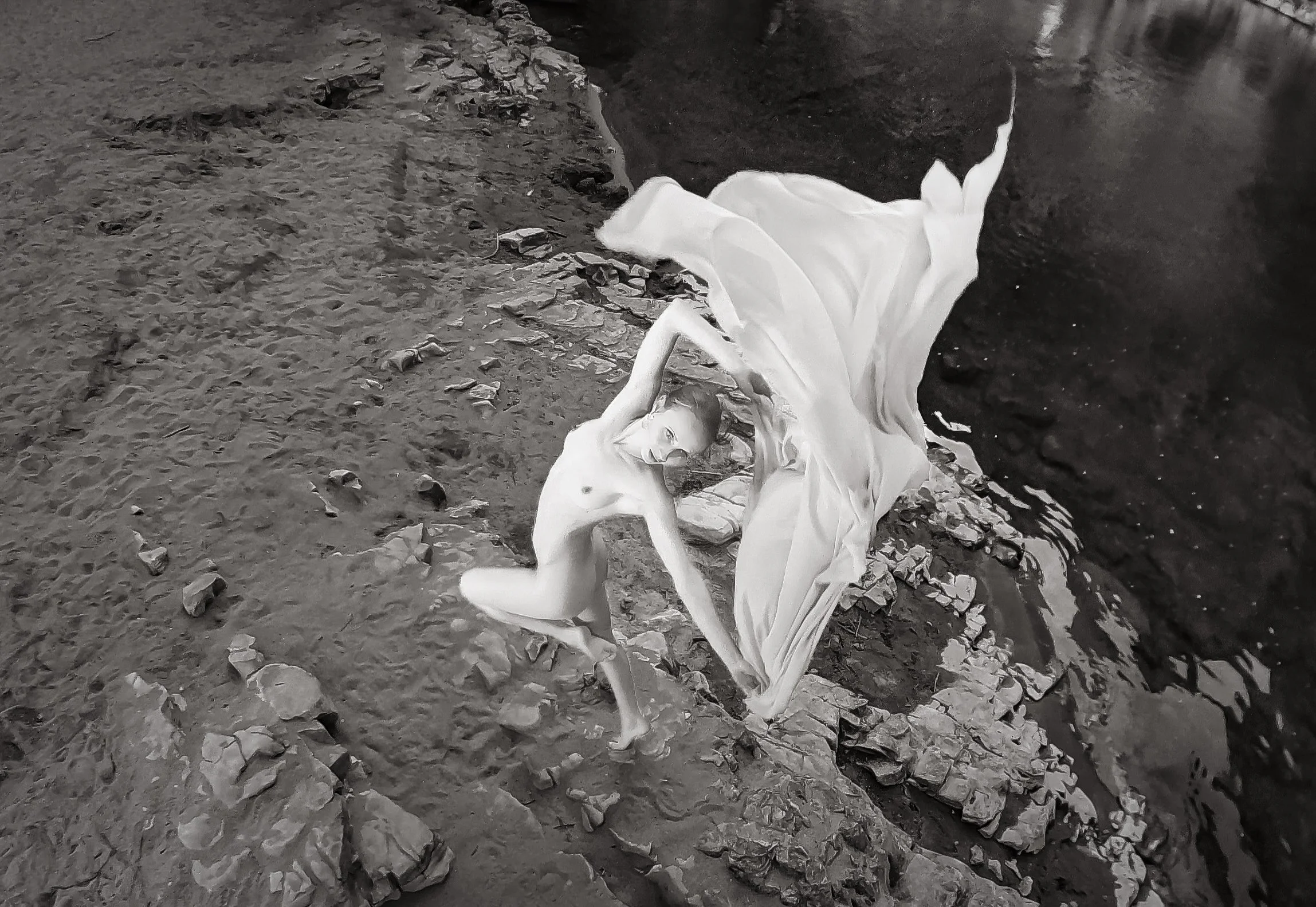 Her body in motion, a ballerina in light; fabric rises like whispered breath, earth and water complement the moment frozen. Grace becomes shape, and silence becomes art.