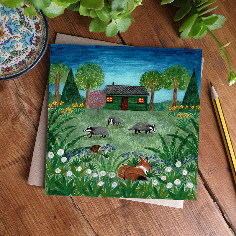Illustrated greeting card showing a cabin and wildlife