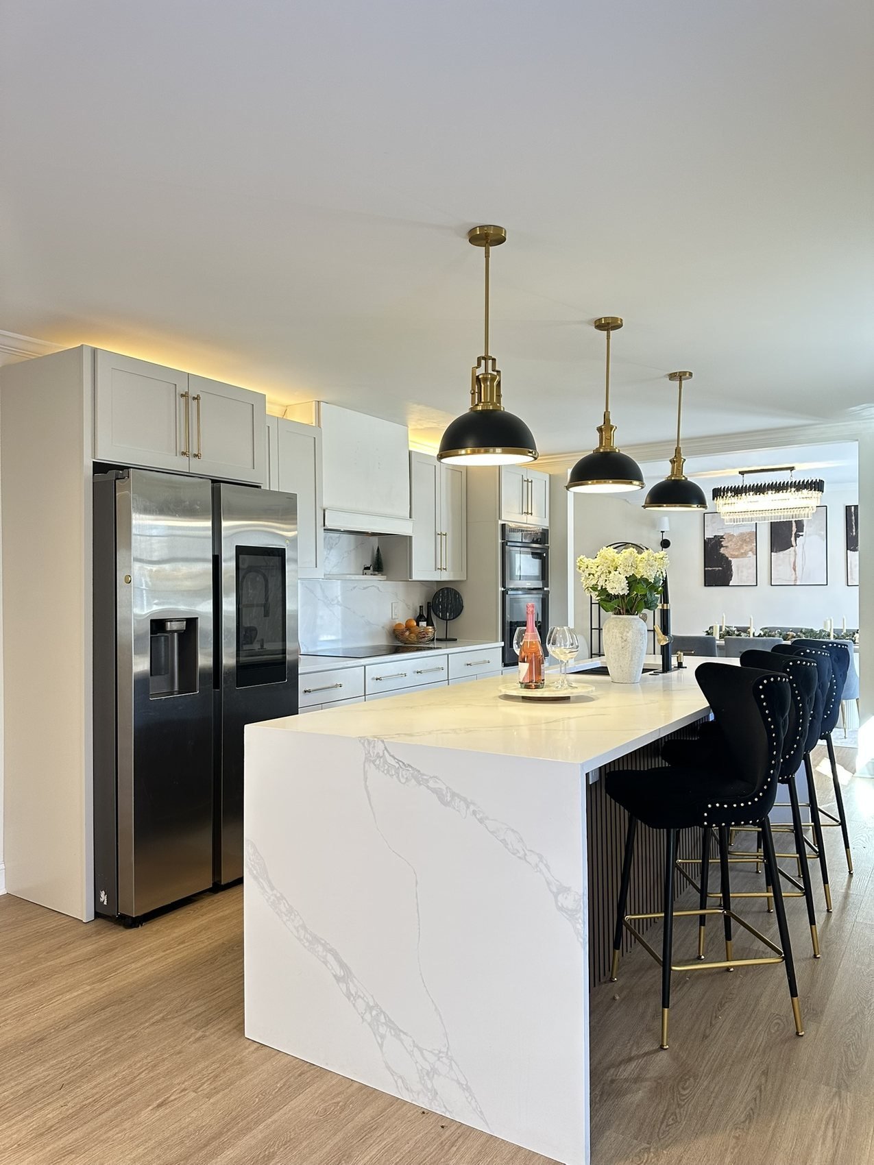 White kitchen with marble waterfall island and black velvet bar stools, Roswell GA remodel
