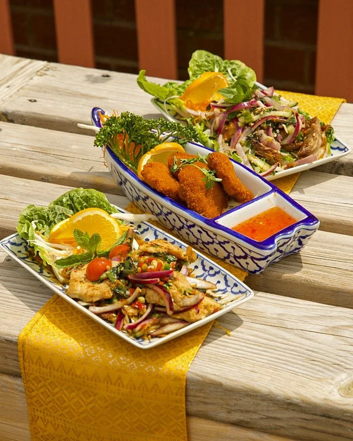Authentic Thai starters at Jup Jup Thai Restaurant in Ludlow, featuring chicken salad, prawn cakes, and crispy duck salad prepared with traditional flavours.